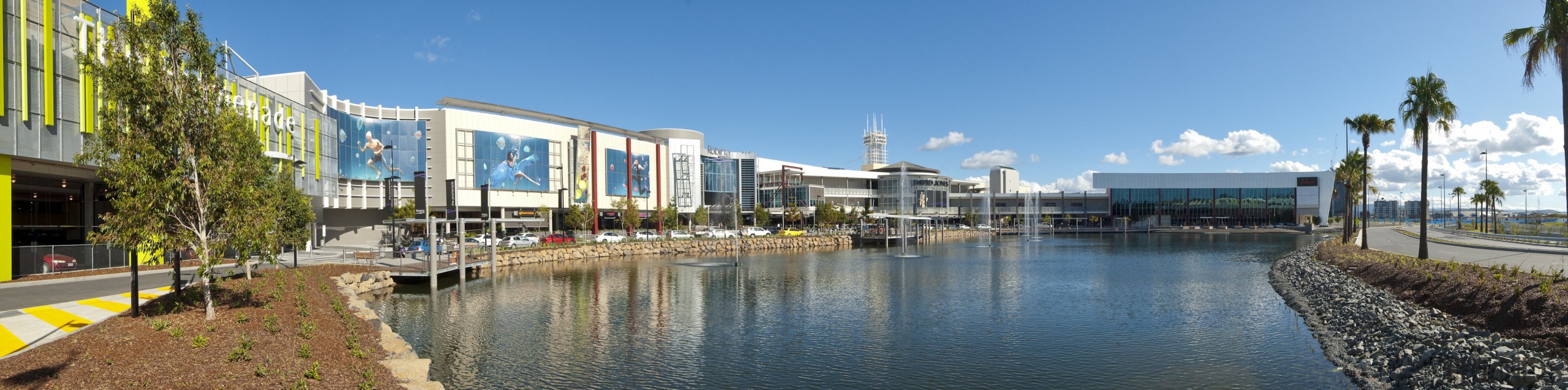 Exterior view of the Robina Town Centre where canal, city, mixed use, real estate, reflection, sky, water, waterway, teal