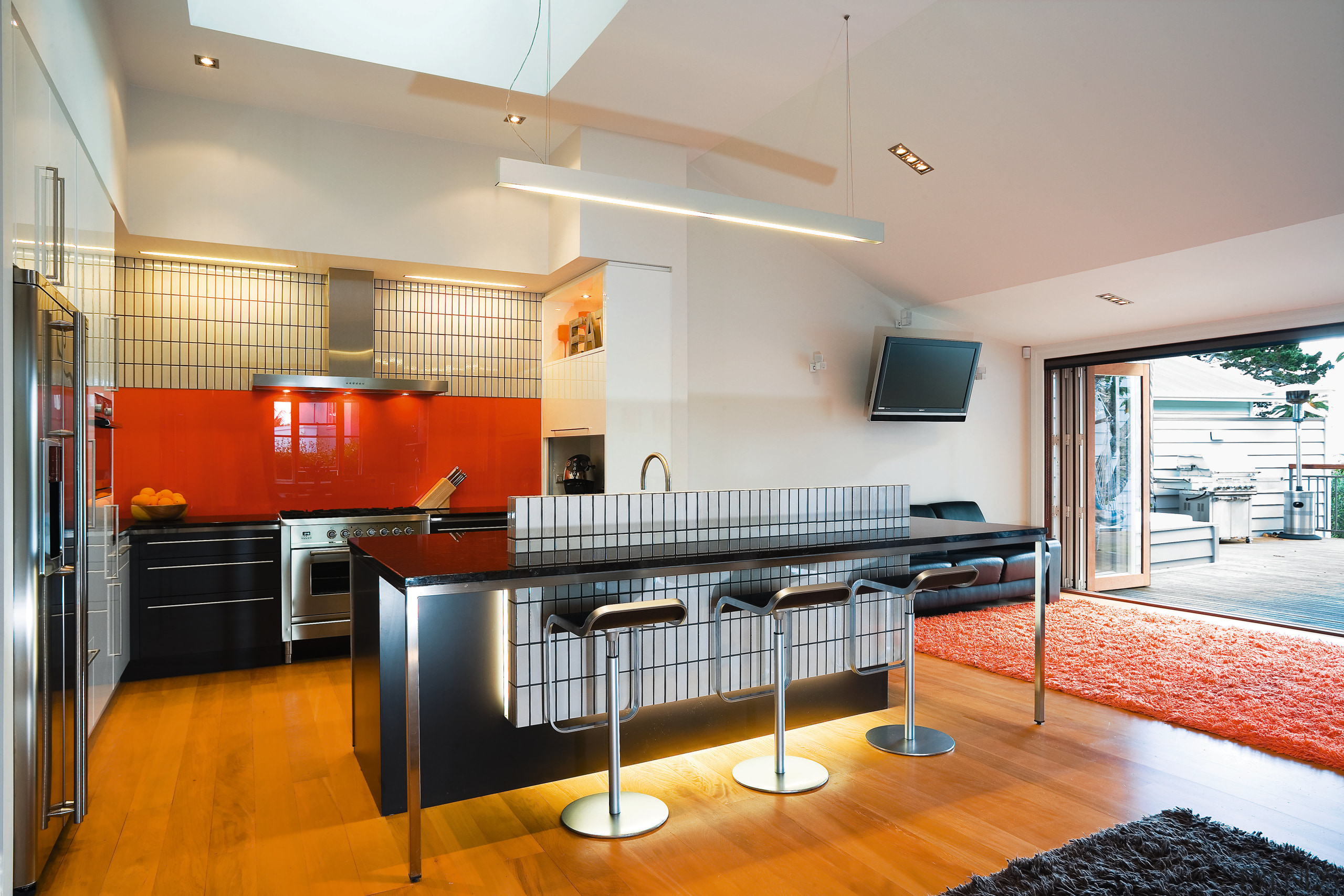 A view of this kitchen featuring kauri flooring, architecture, countertop, house, interior design, kitchen, loft, real estate, room, gray