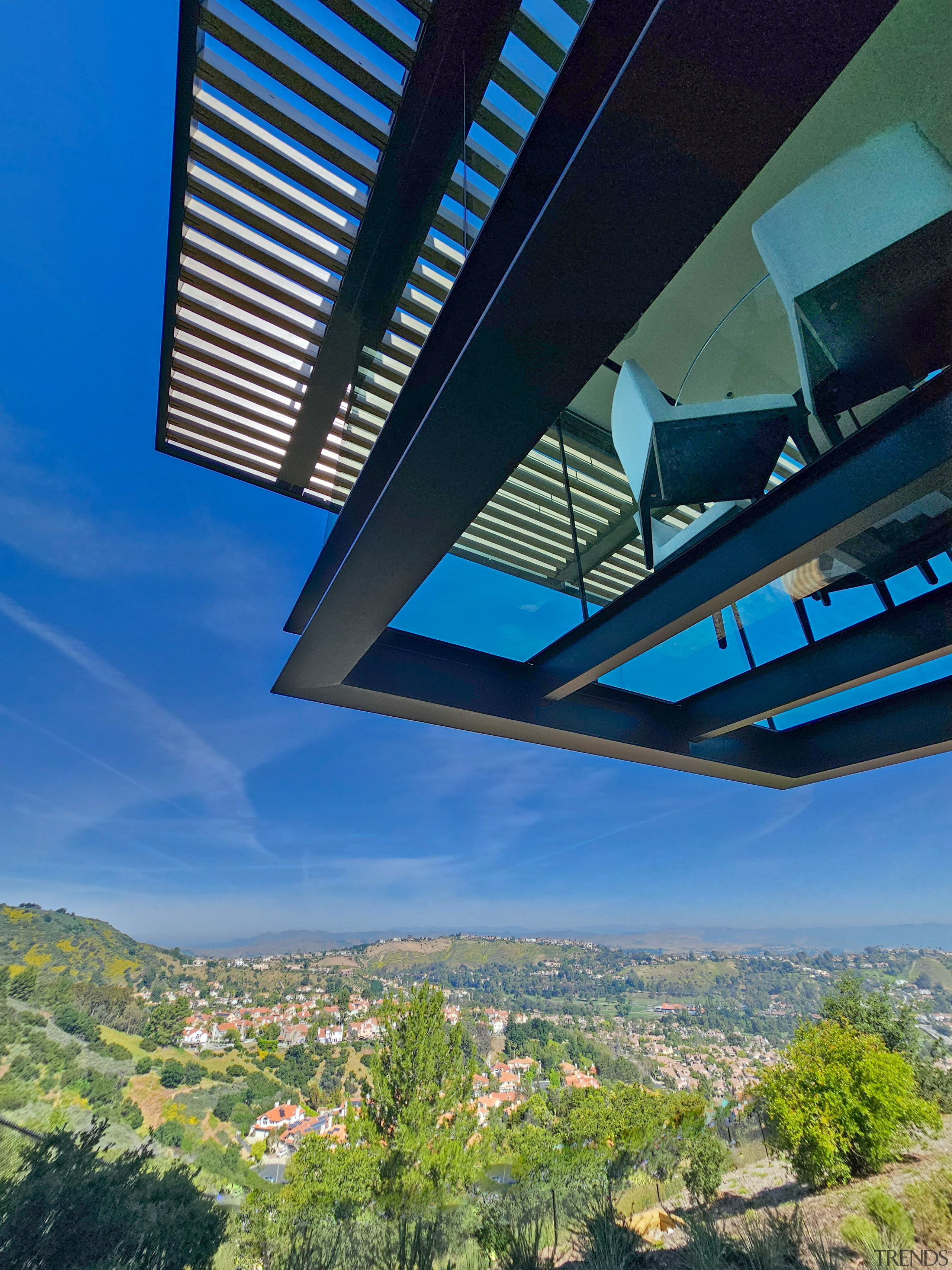 The dramatically cantilevered, glass-floored dinette from below. 