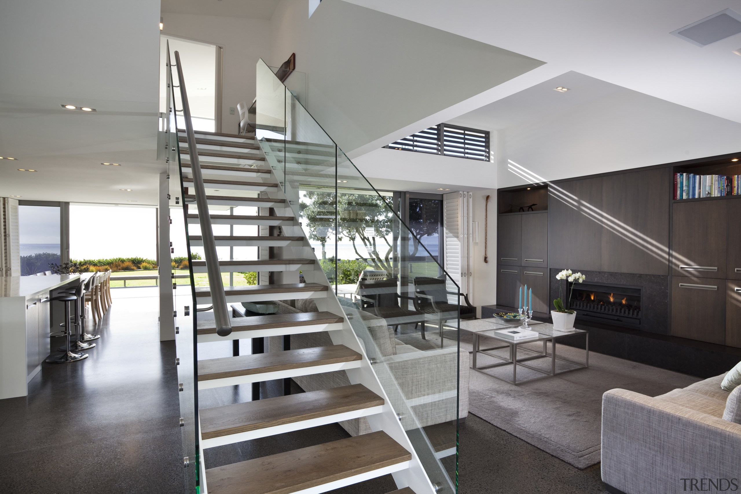 This house was designed by Hamish Cameron NZIA architecture, condominium, handrail, house, interior design, living room, real estate, stairs, gray