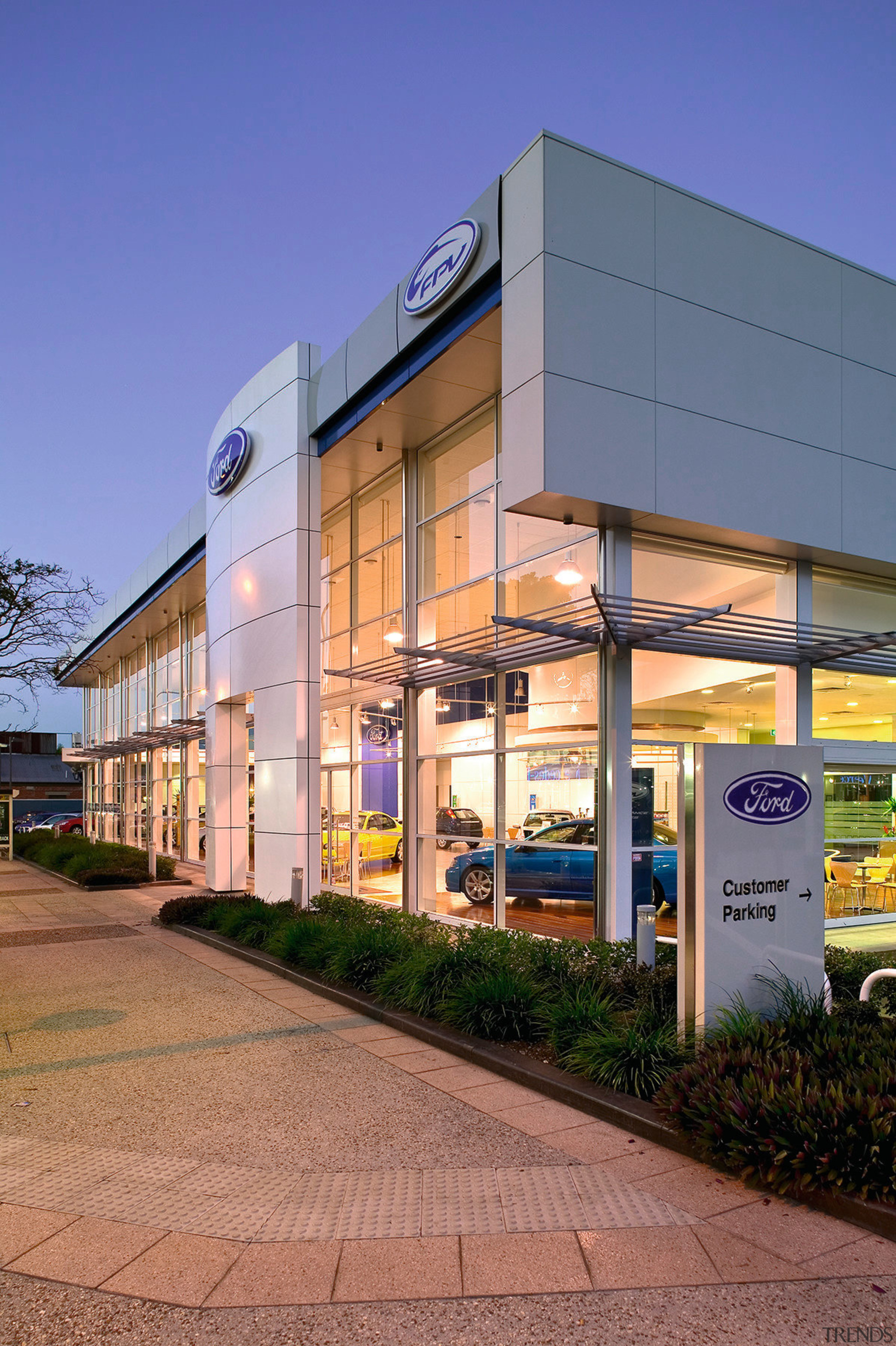 view of the ford showroom with  double architecture, building, commercial building, corporate headquarters, facade, mixed use, real estate, blue