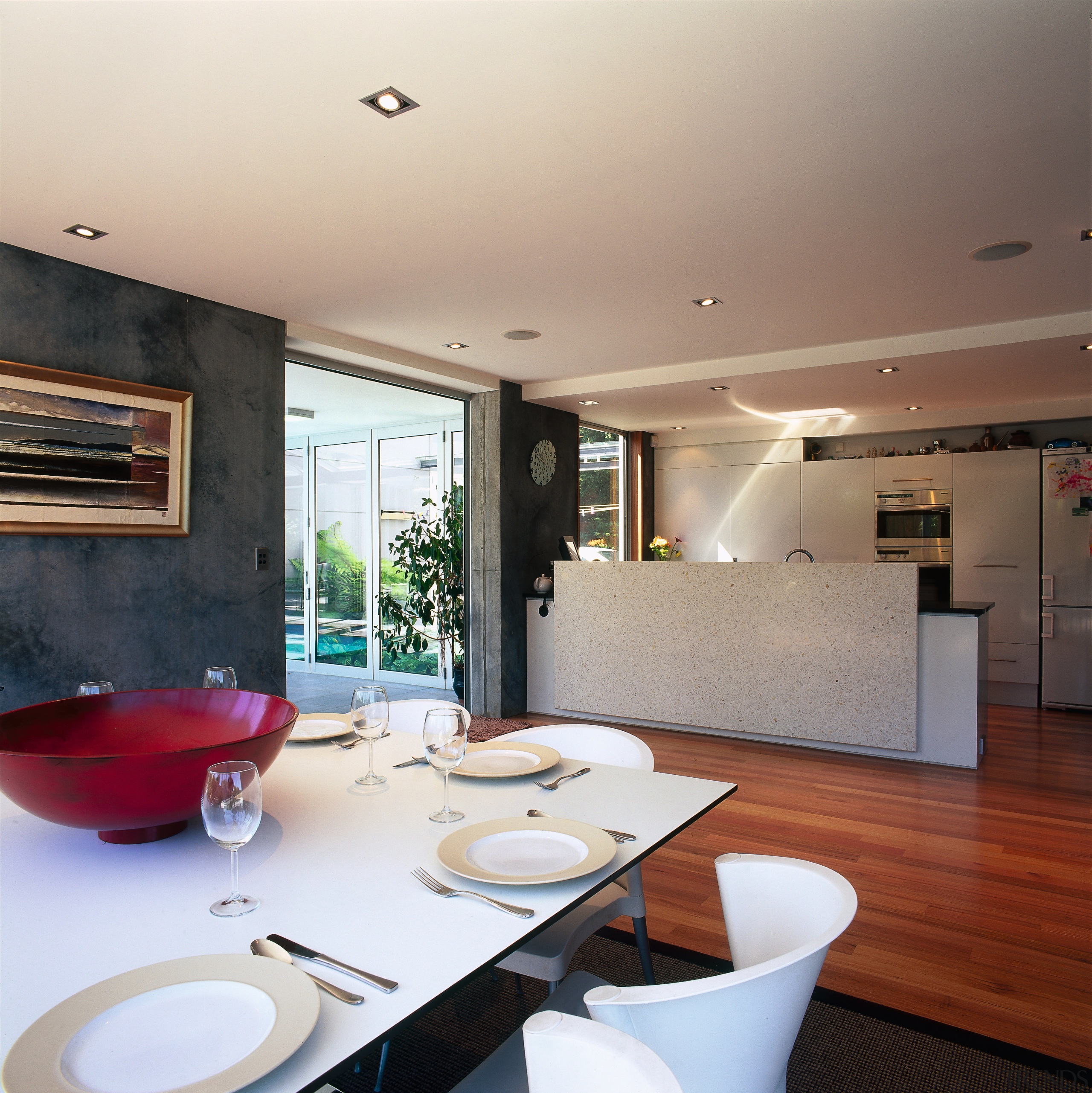 A interior view of the dining area featuring architecture, ceiling, countertop, home, house, interior design, kitchen, living room, property, real estate, room, table, window, gray