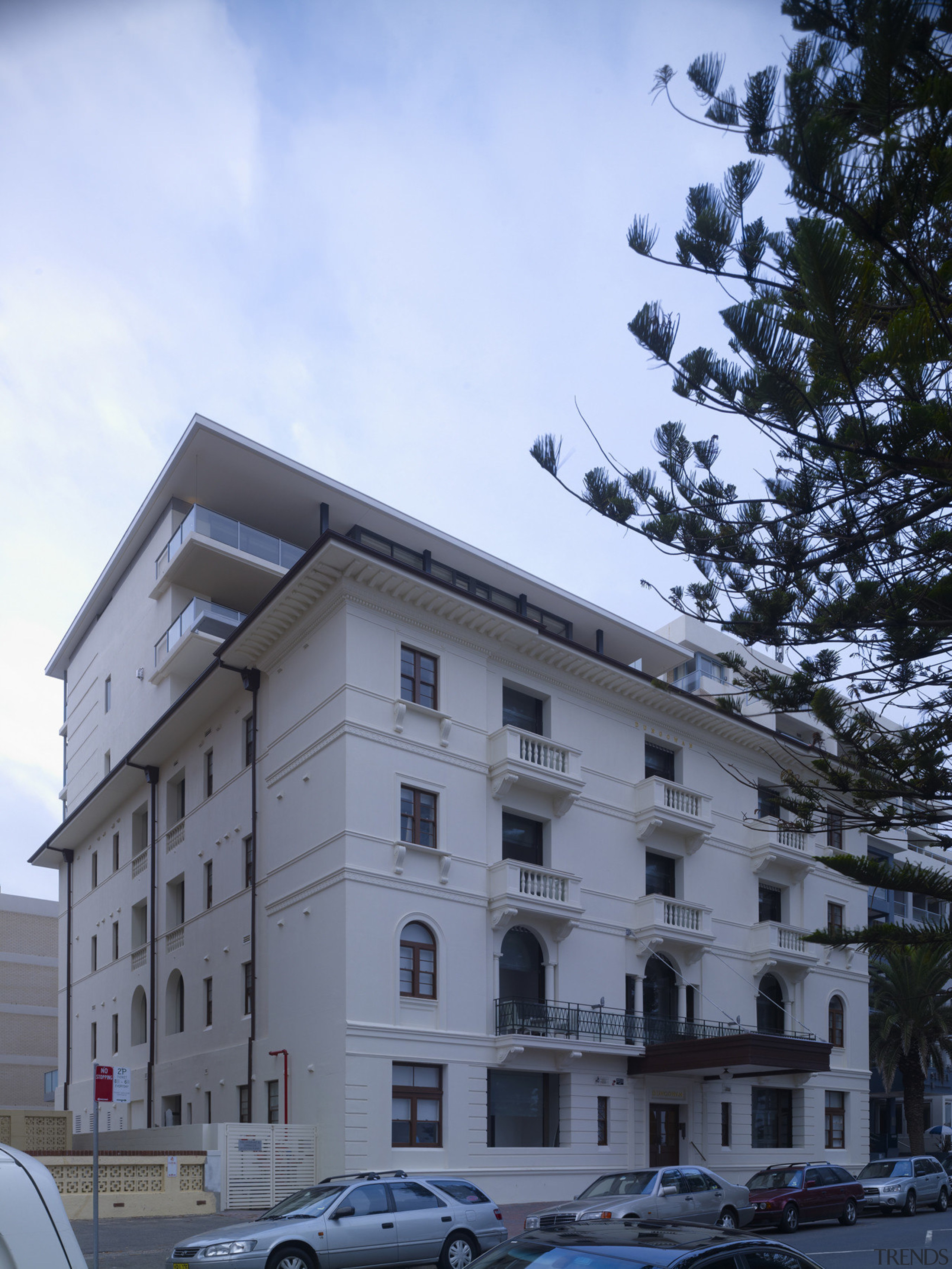 Exterior view of restored historic apartment building. apartment, architecture, building, condominium, facade, home, house, property, real estate, residential area, roof, sky, window, teal