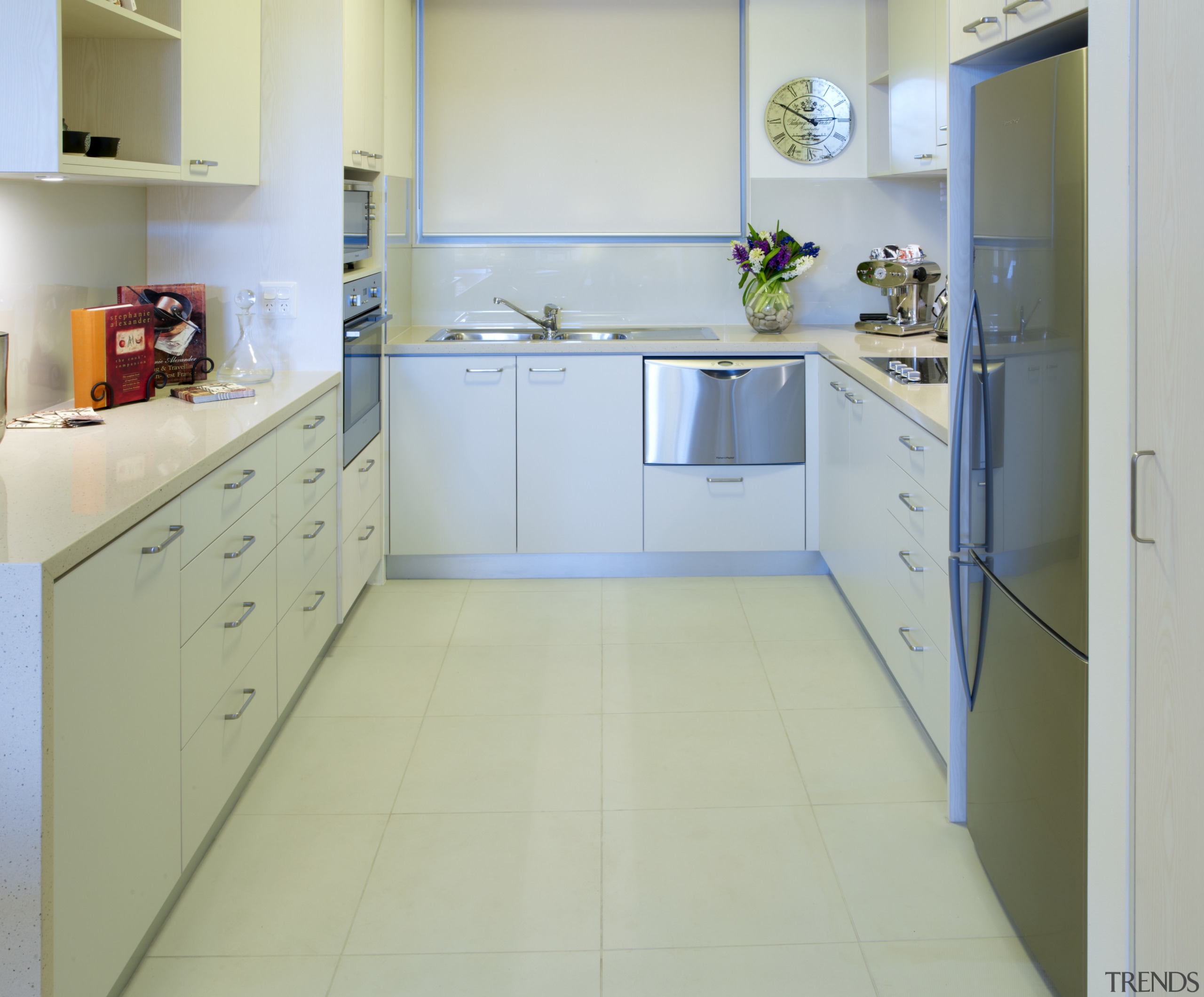 View of the kitchen of a unit at cabinetry, countertop, floor, flooring, interior design, kitchen, room, tile, green, gray