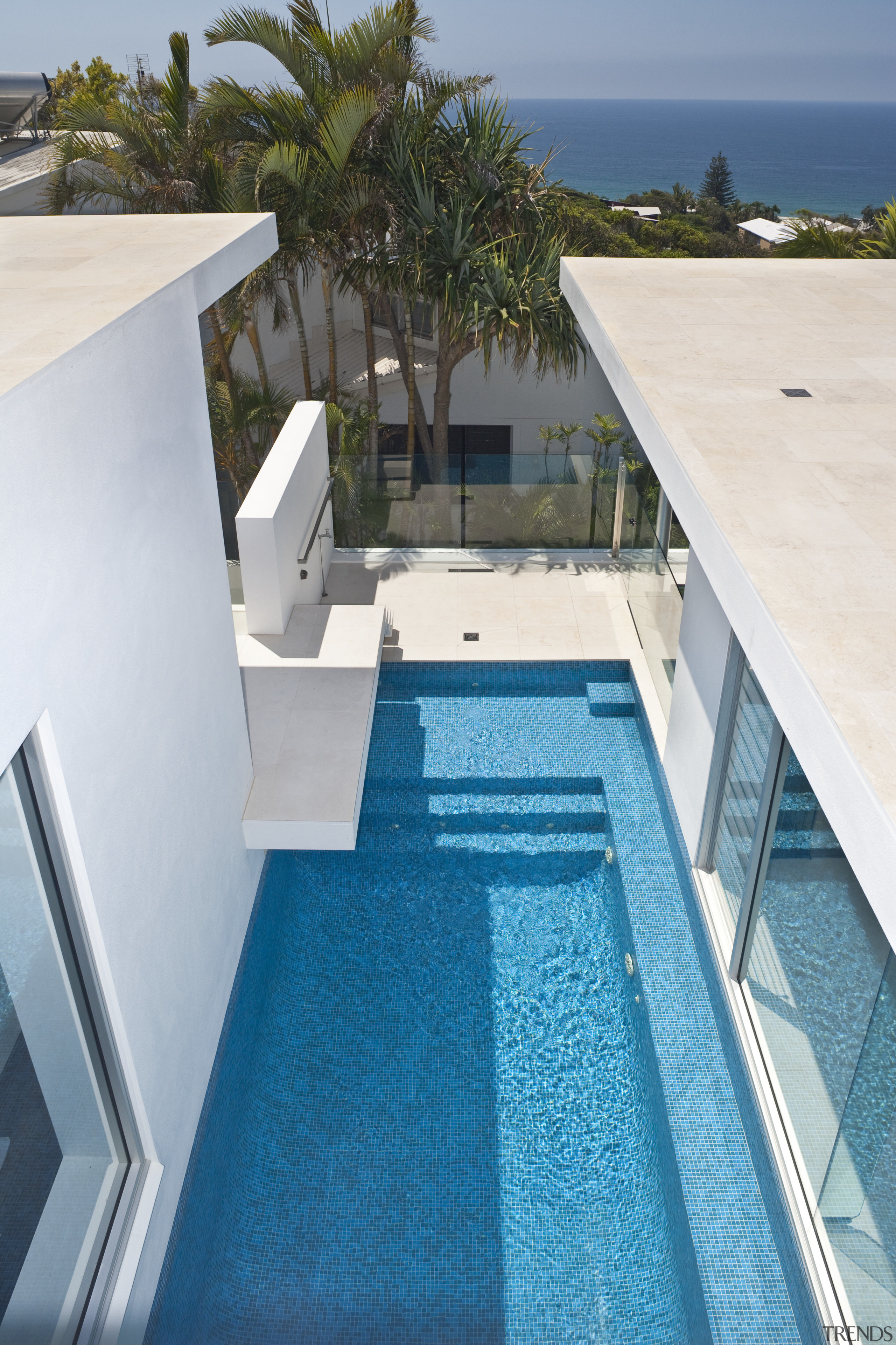 View of rooftop terrace which features paving, outdoor architecture, condominium, estate, home, house, leisure, property, real estate, resort, swimming pool, villa, teal, gray