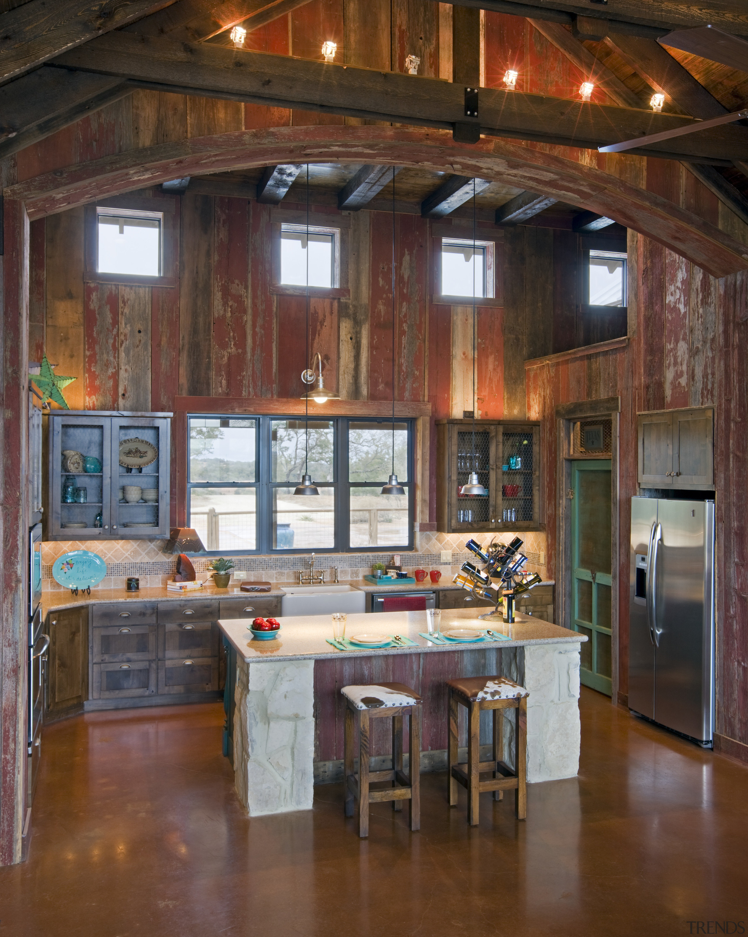 View of a farmhouse styled kitchen which features beam, cabinetry, ceiling, countertop, hardwood, home, interior design, kitchen, room, table, wood, brown