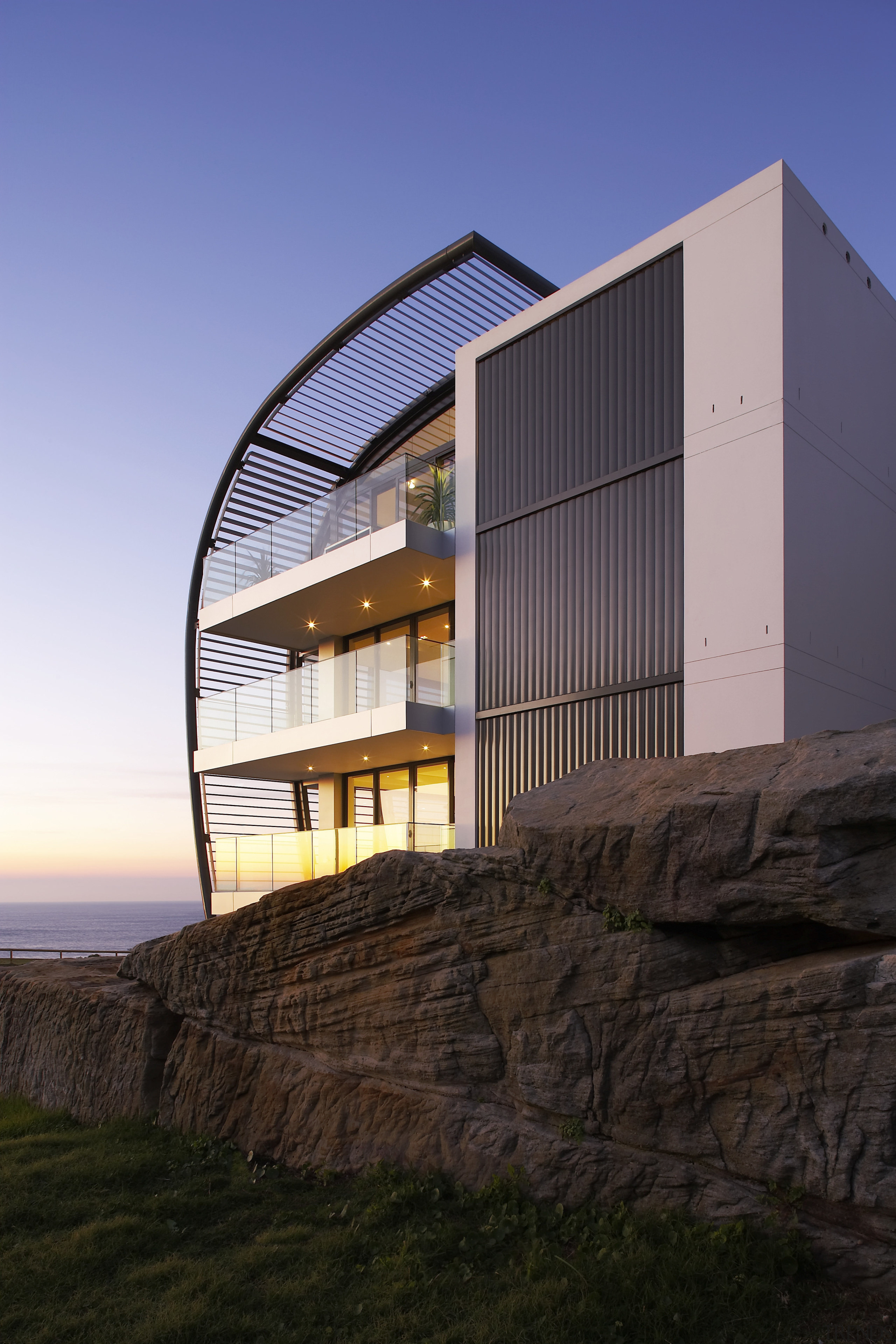 Exterior view of a Sydney apartment building which architecture, building, corporate headquarters, facade, home, house, real estate, reflection, residential area, sky, black