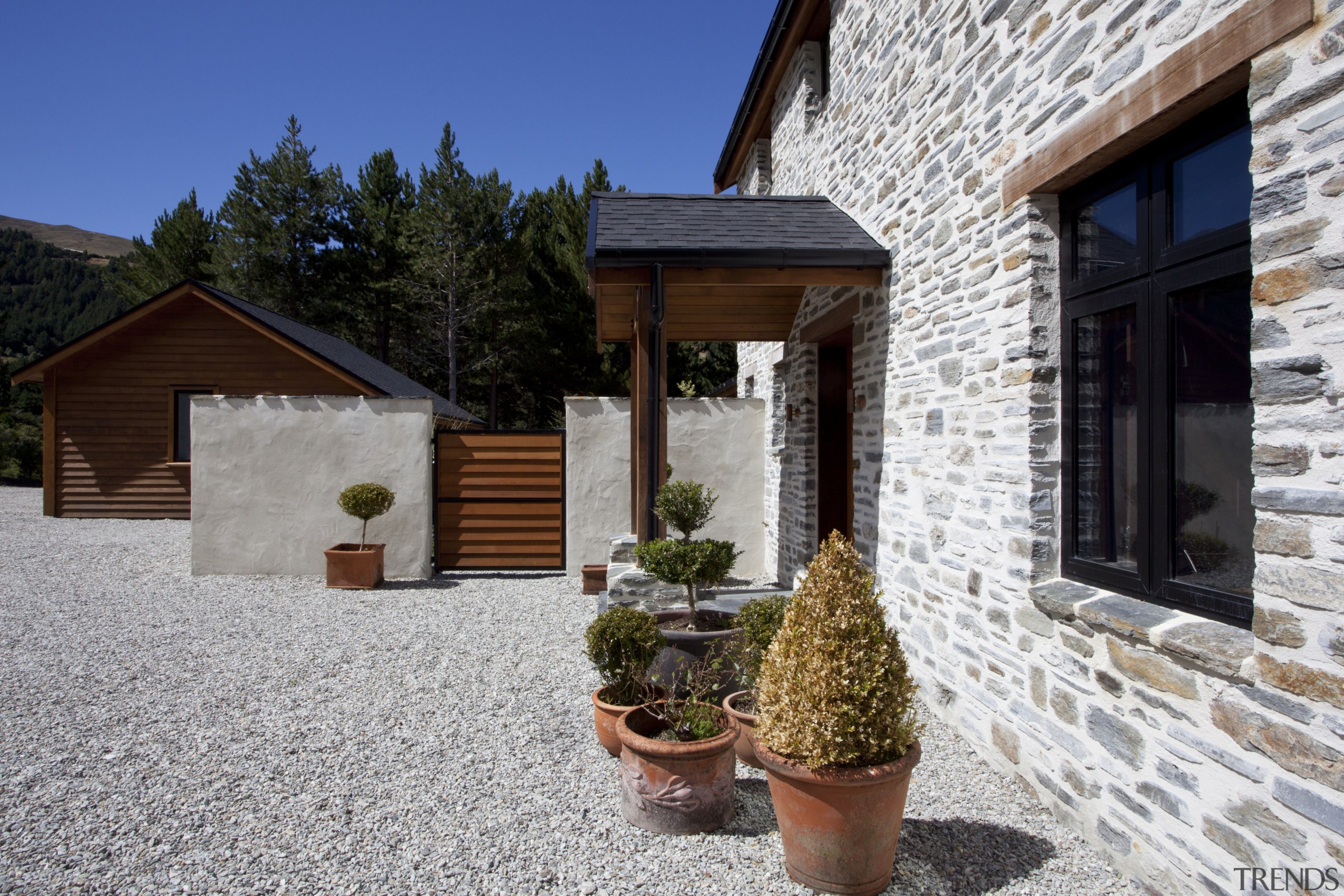 View of entrance with potted plants and stone cottage, estate, facade, home, house, property, real estate, gray