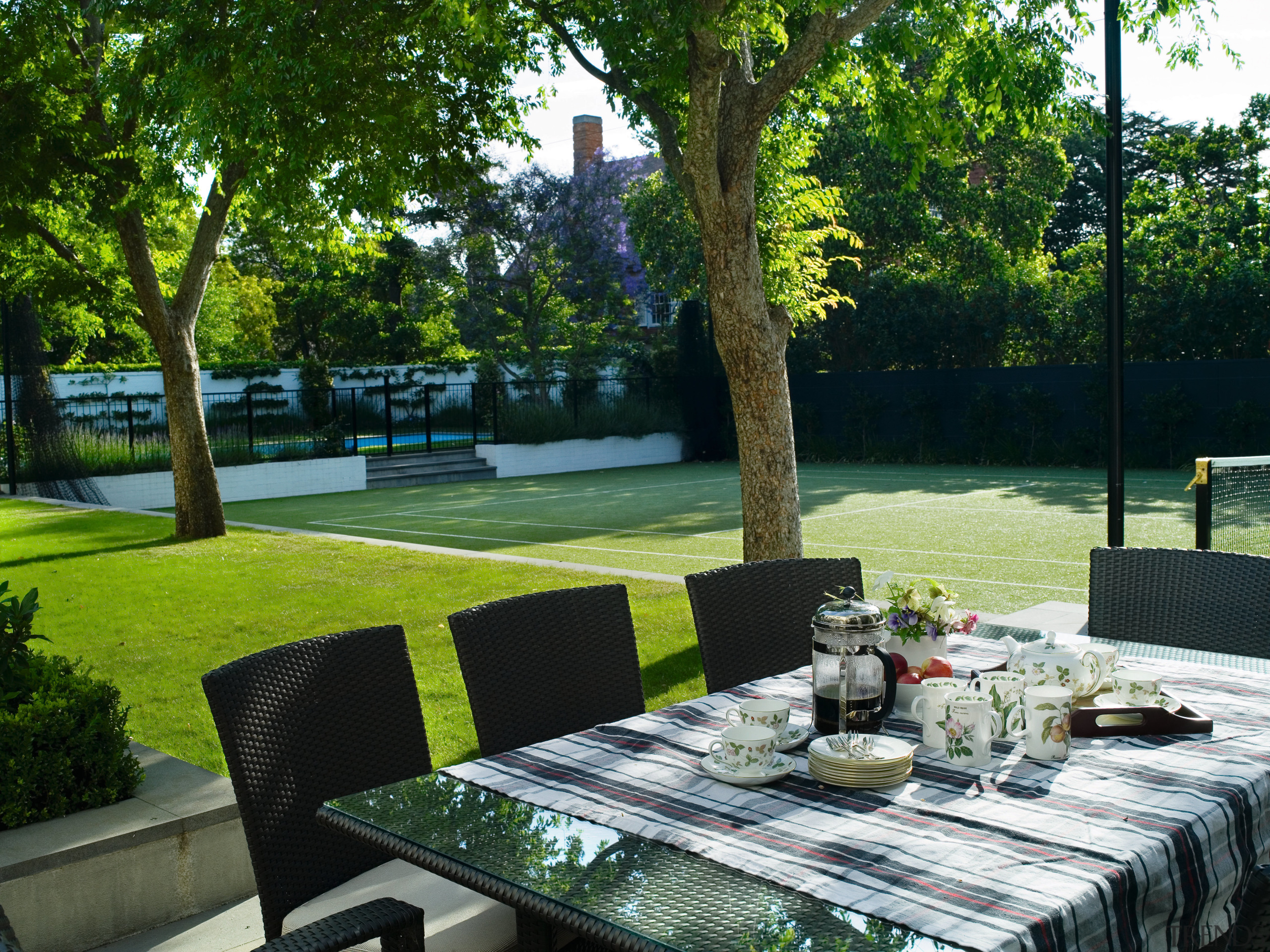 A view of the outdoor entertaining area featuring backyard, estate, garden, grass, house, lawn, outdoor structure, plant, property, real estate, table, tree, yard, green, black