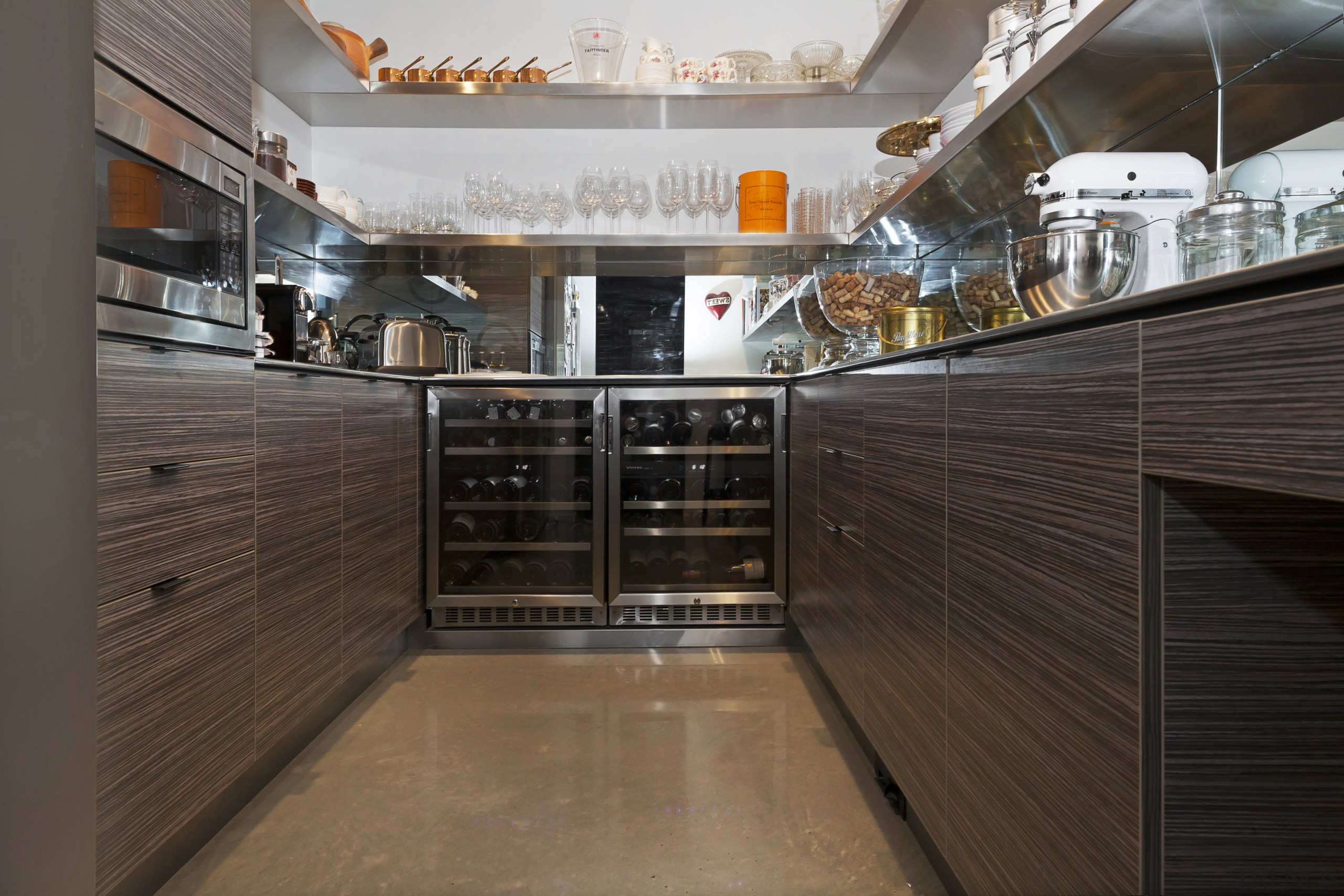 A two-door wine fridge takes care of party cabinetry, countertop, floor, flooring, interior design, kitchen, wood, black, gray