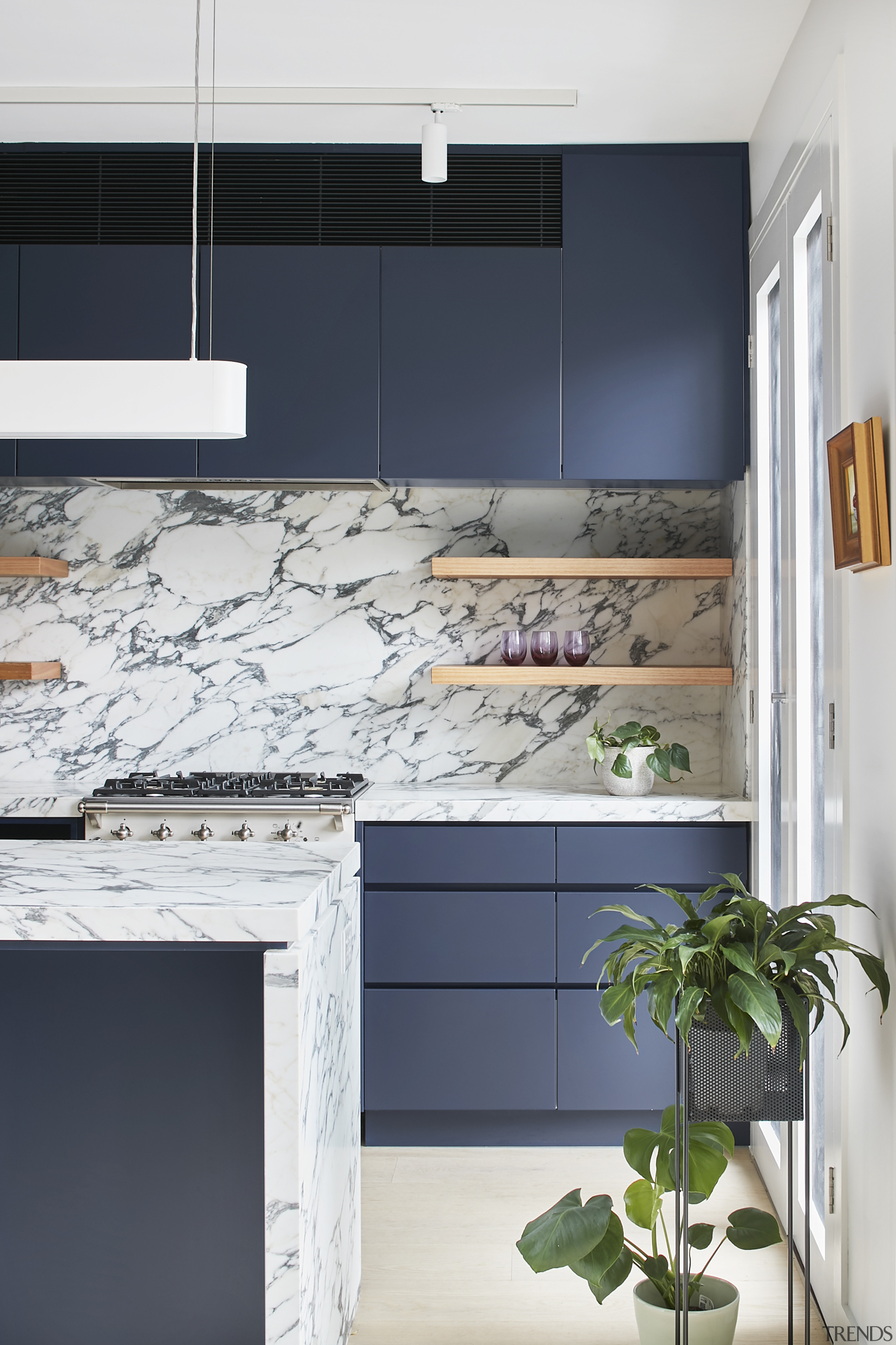 ​​​​​​​The island’s marble waterfall benchtop with negative detail cabinetry, countertop, floor, interior design, kitchen, marble waterfall, grey cabinetryRob Nerlich, Mcmahon and Nerlich