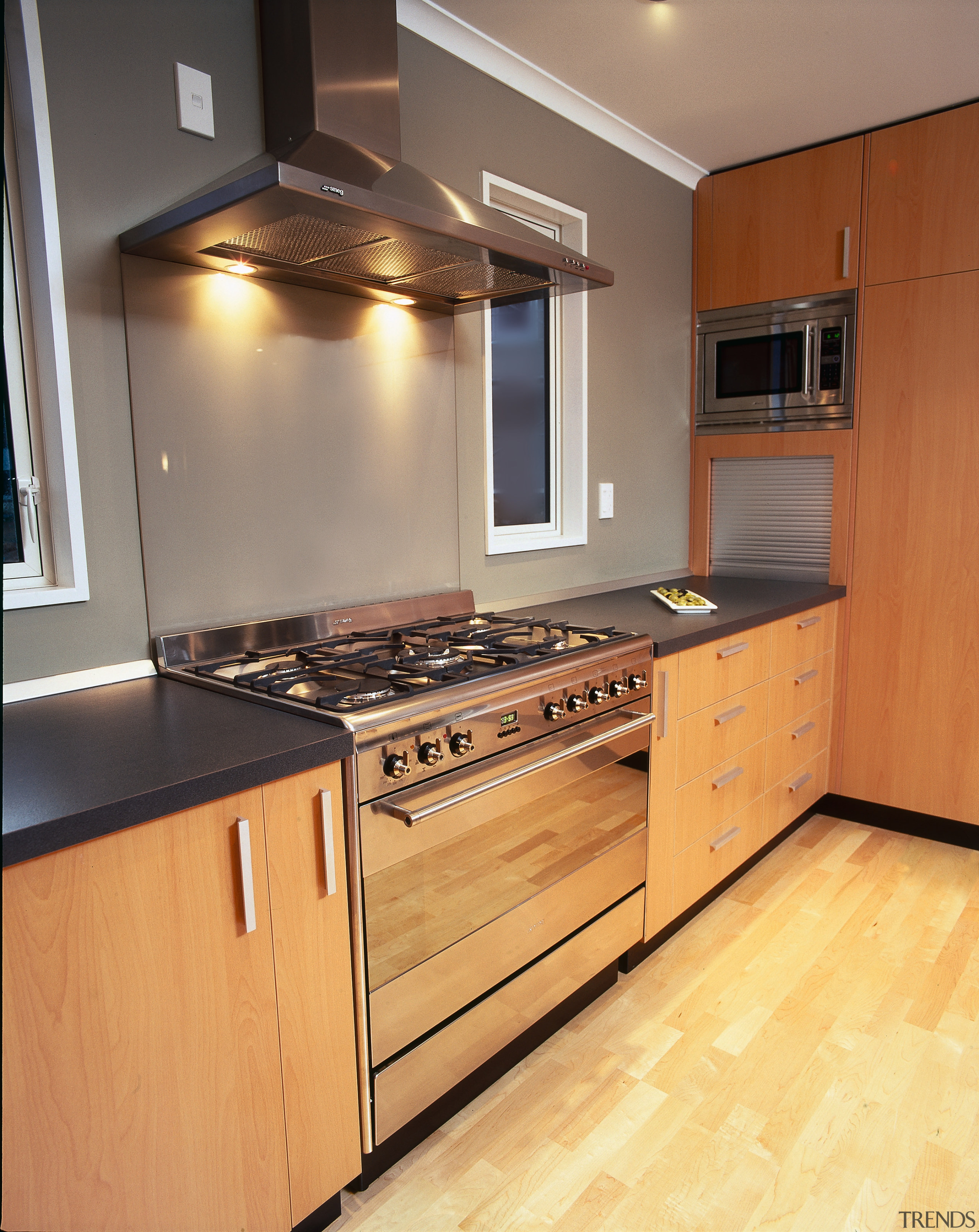 Kitchen with wooden cabinetry and black benchtop, stainless cabinetry, countertop, cuisine classique, floor, flooring, hardwood, interior design, kitchen, room, wood, wood flooring, orange