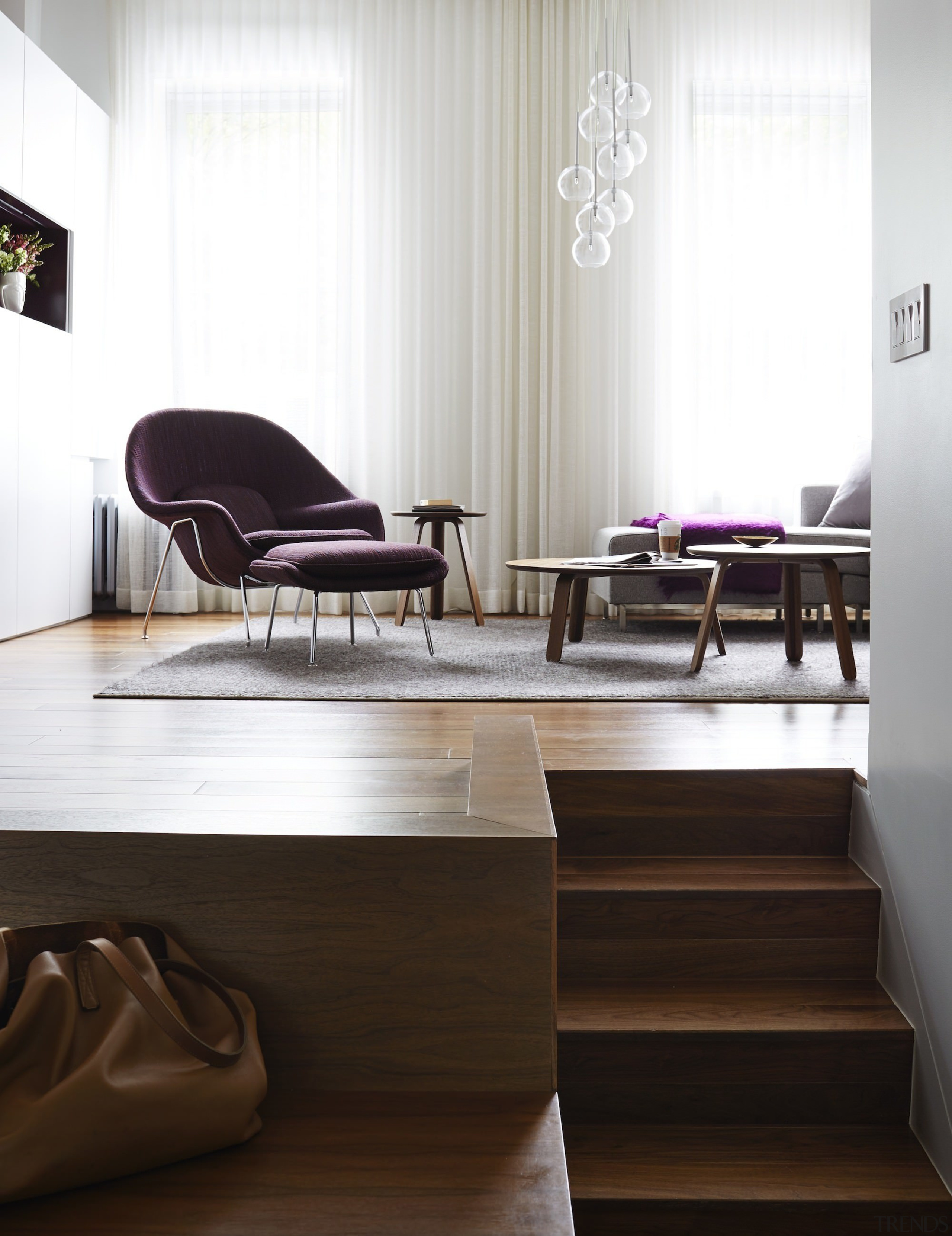 The stairway leading up to the living area floor, flooring, furniture, hardwood, interior design, laminate flooring, living room, product design, table, wood, wood flooring, white, black