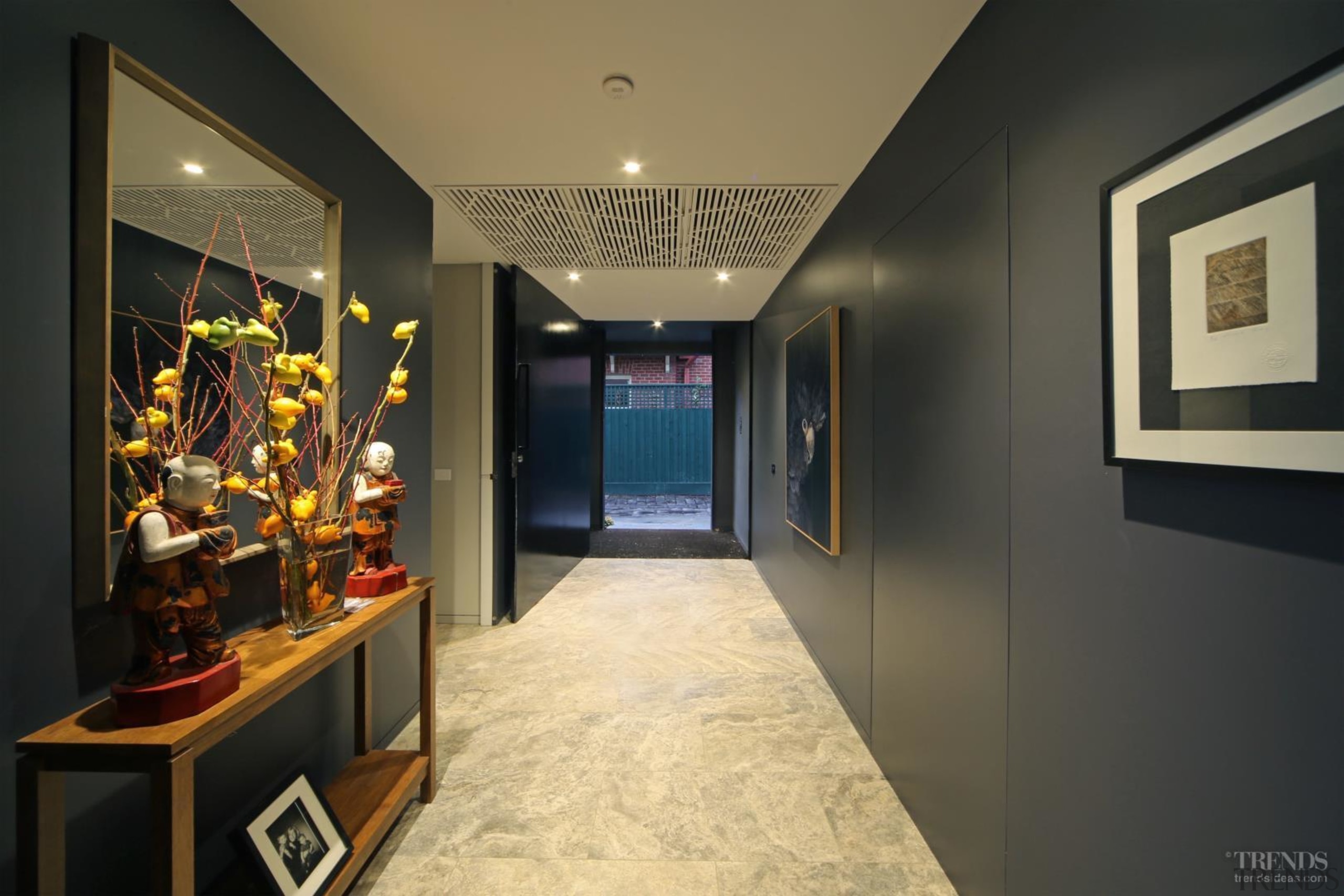 A deliberately compressed hallway makes the arrival into boutique, ceiling, interior design, lobby, room, black, brown