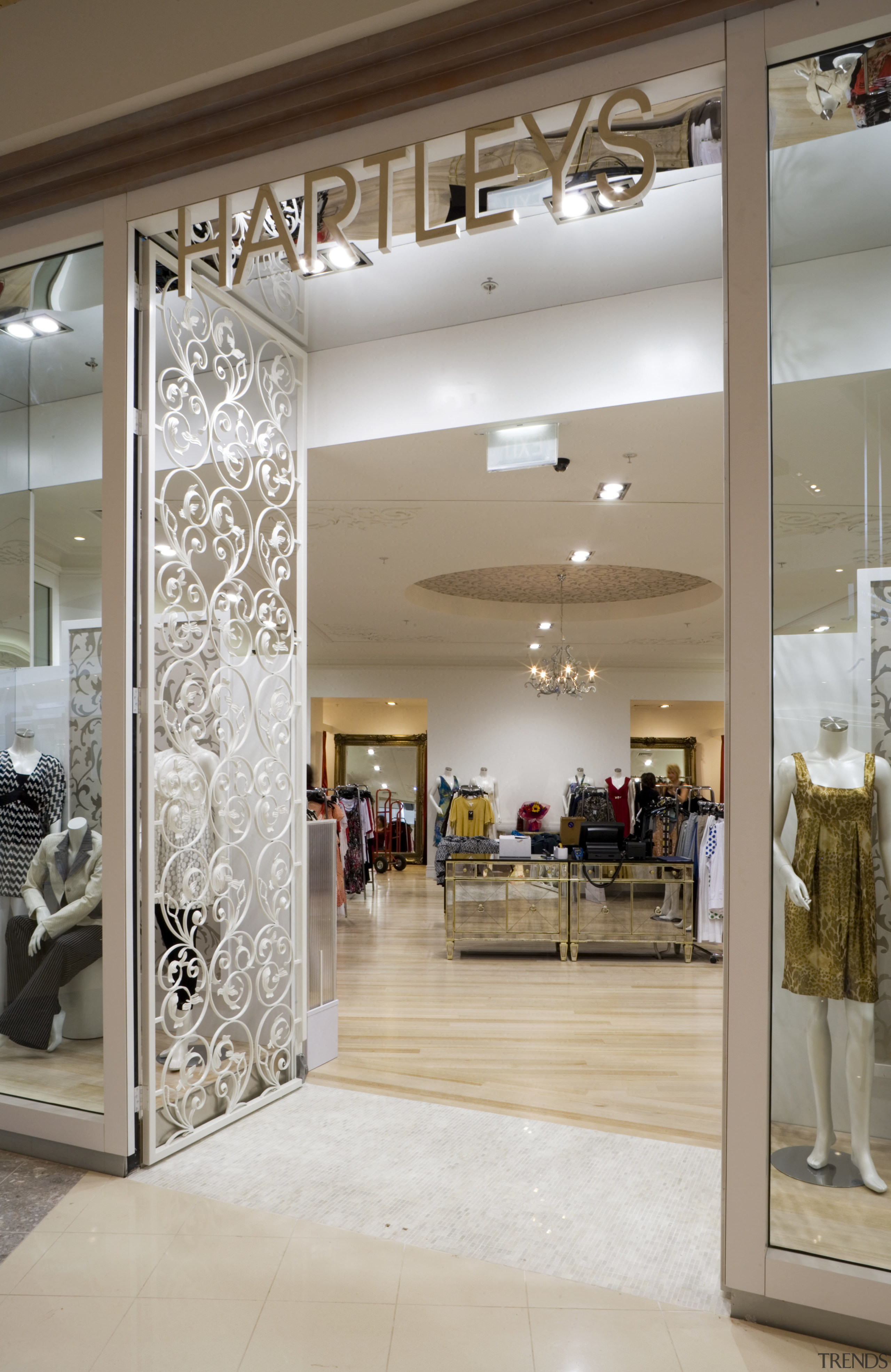 Wrought iron gates provide a distinctive entrance for boutique, ceiling, floor, flooring, interior design, lobby, retail, gray, brown