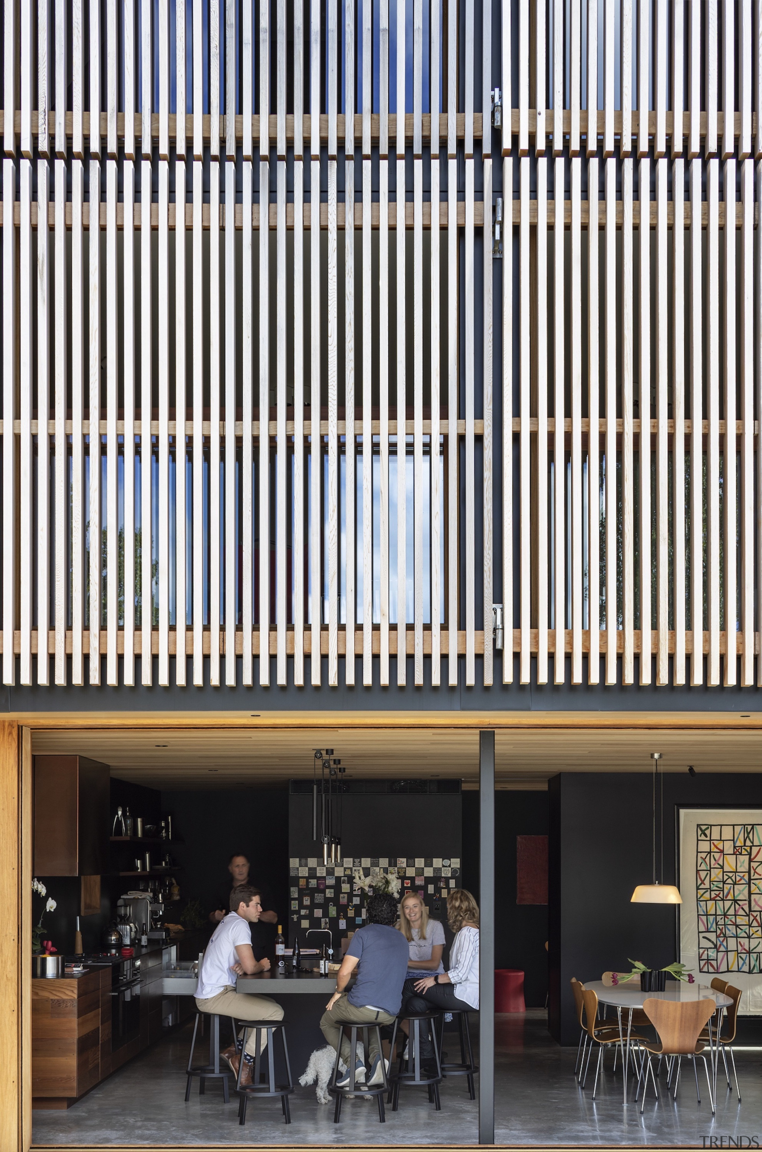 The contemporary family home opens to the outdoors 