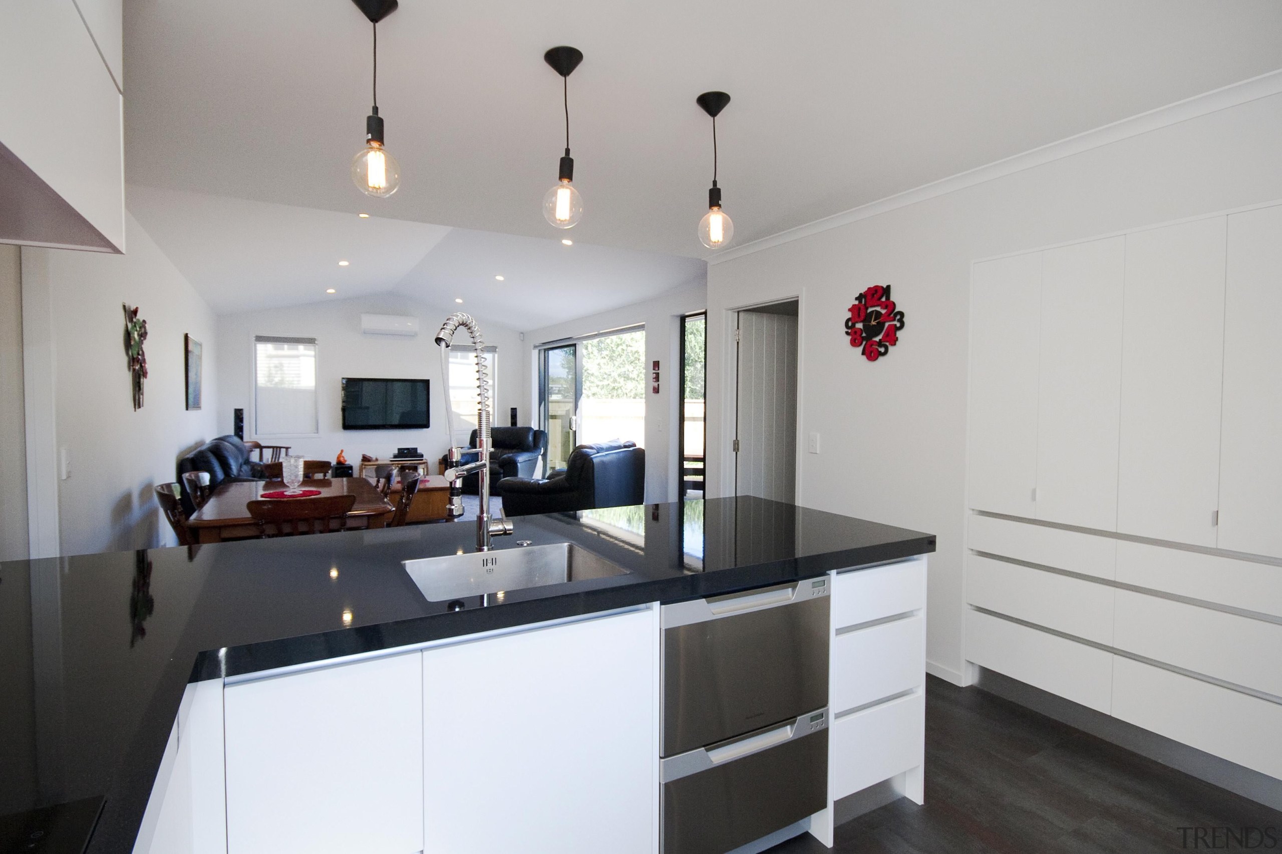 Open plan kitchen-living area in a town house.Fowler countertop, interior design, kitchen, property, real estate, room, gray