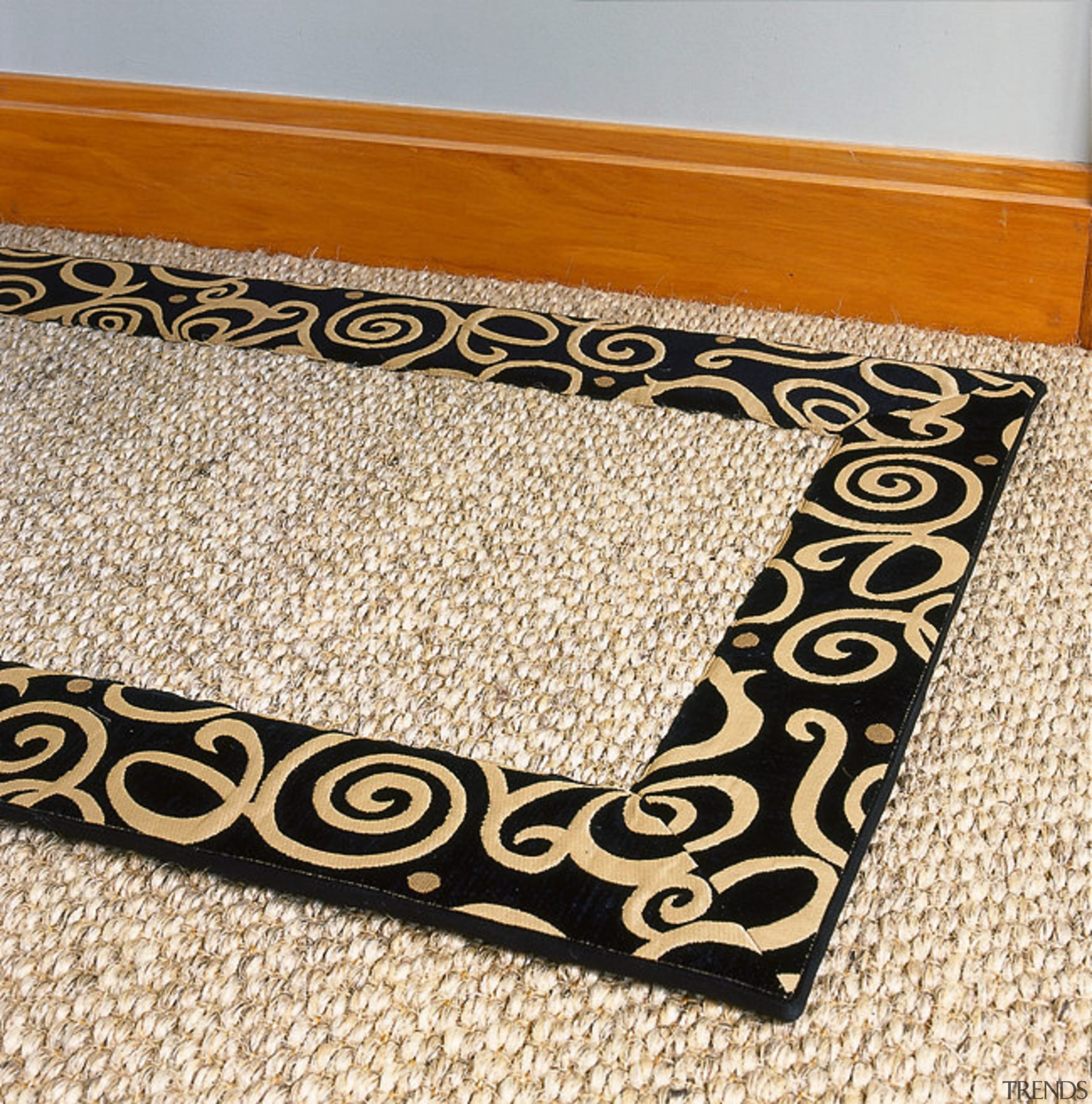 view of textured carpet with a black boarder flooring, mat, orange