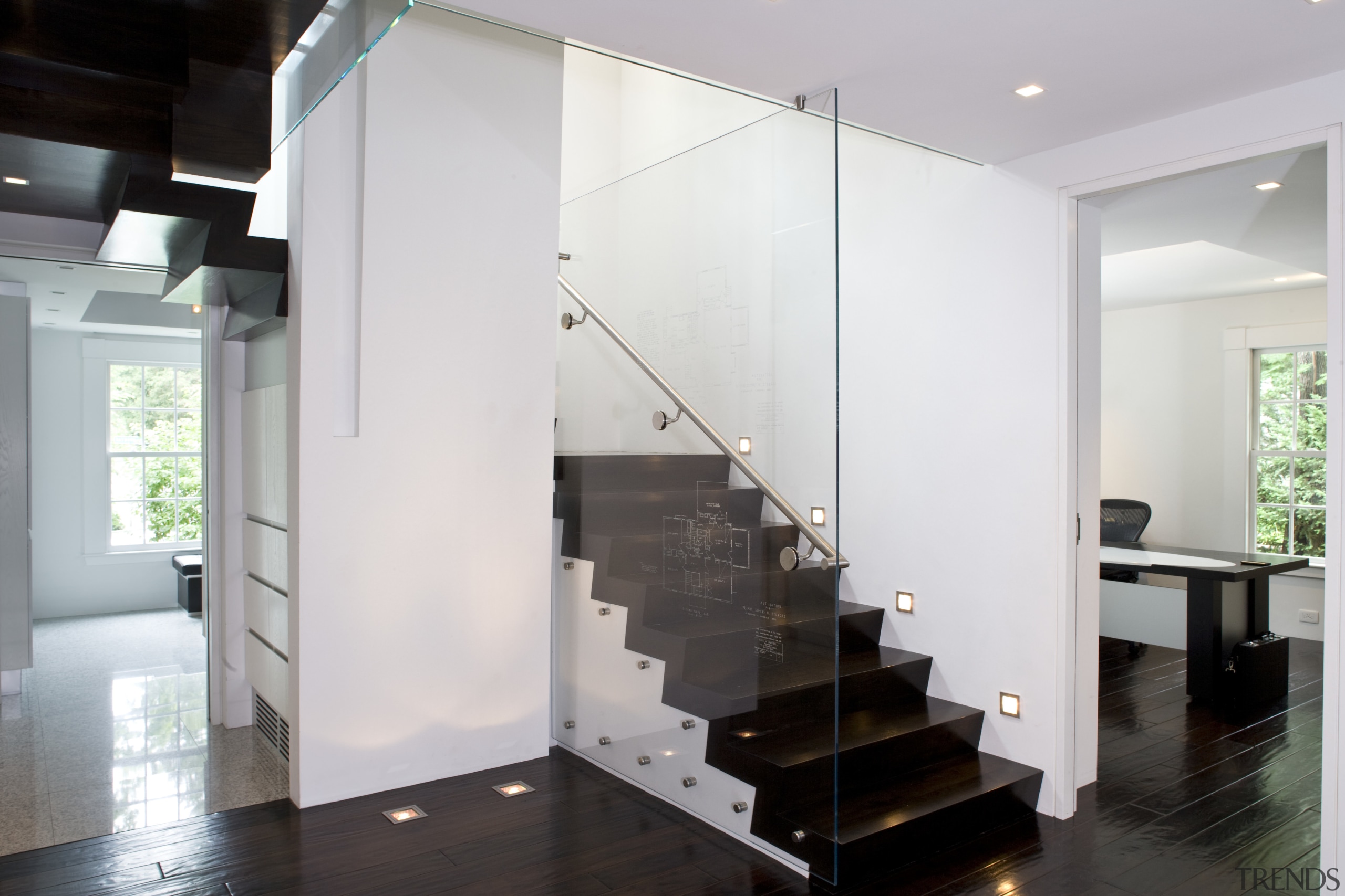 View of a stairway with glass balustrade and floor, flooring, glass, handrail, interior design, stairs, wall, white