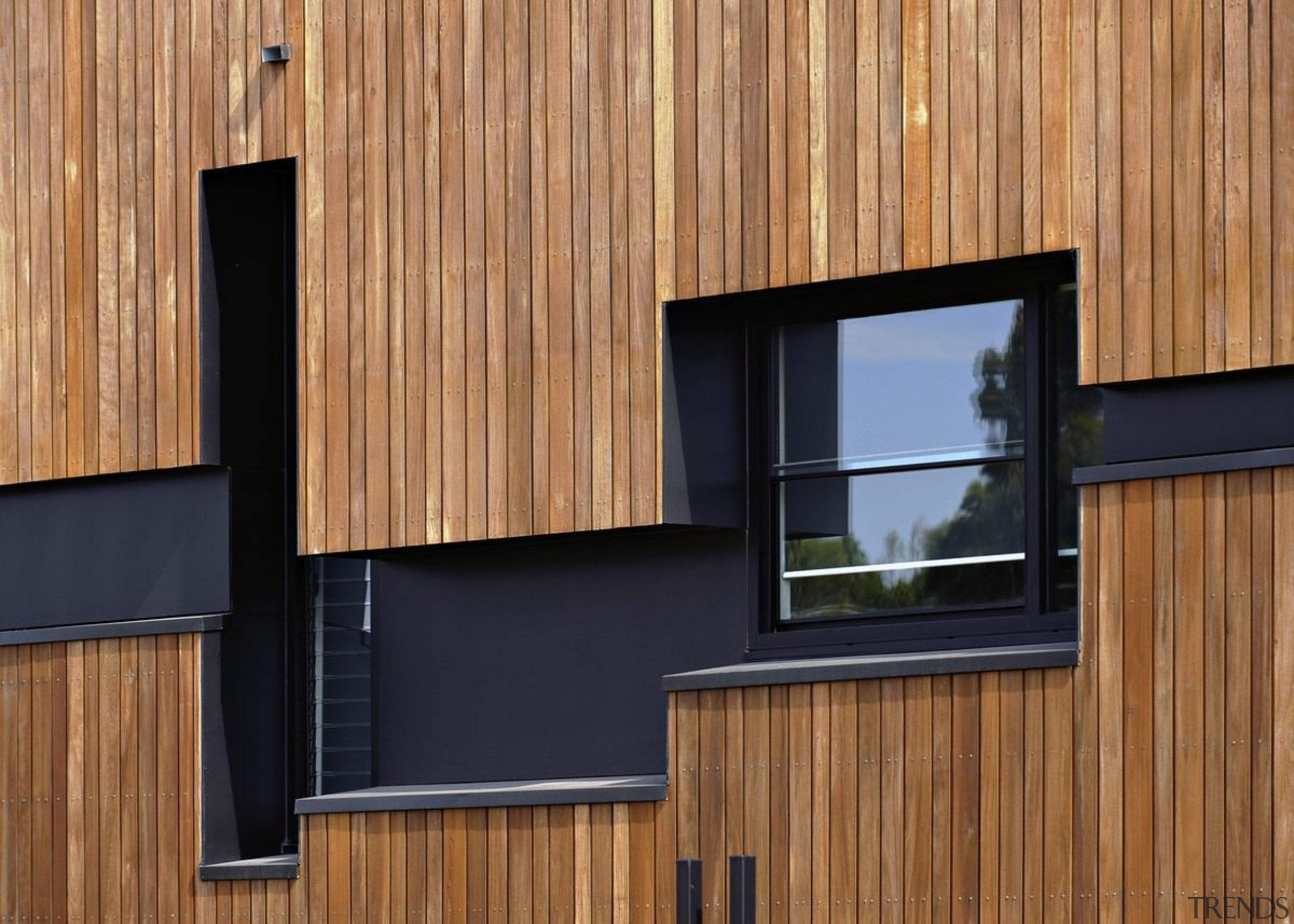 The structure around the windows helps with privacy architecture, facade, home, house, siding, wall, window, wood, brown, orange, black