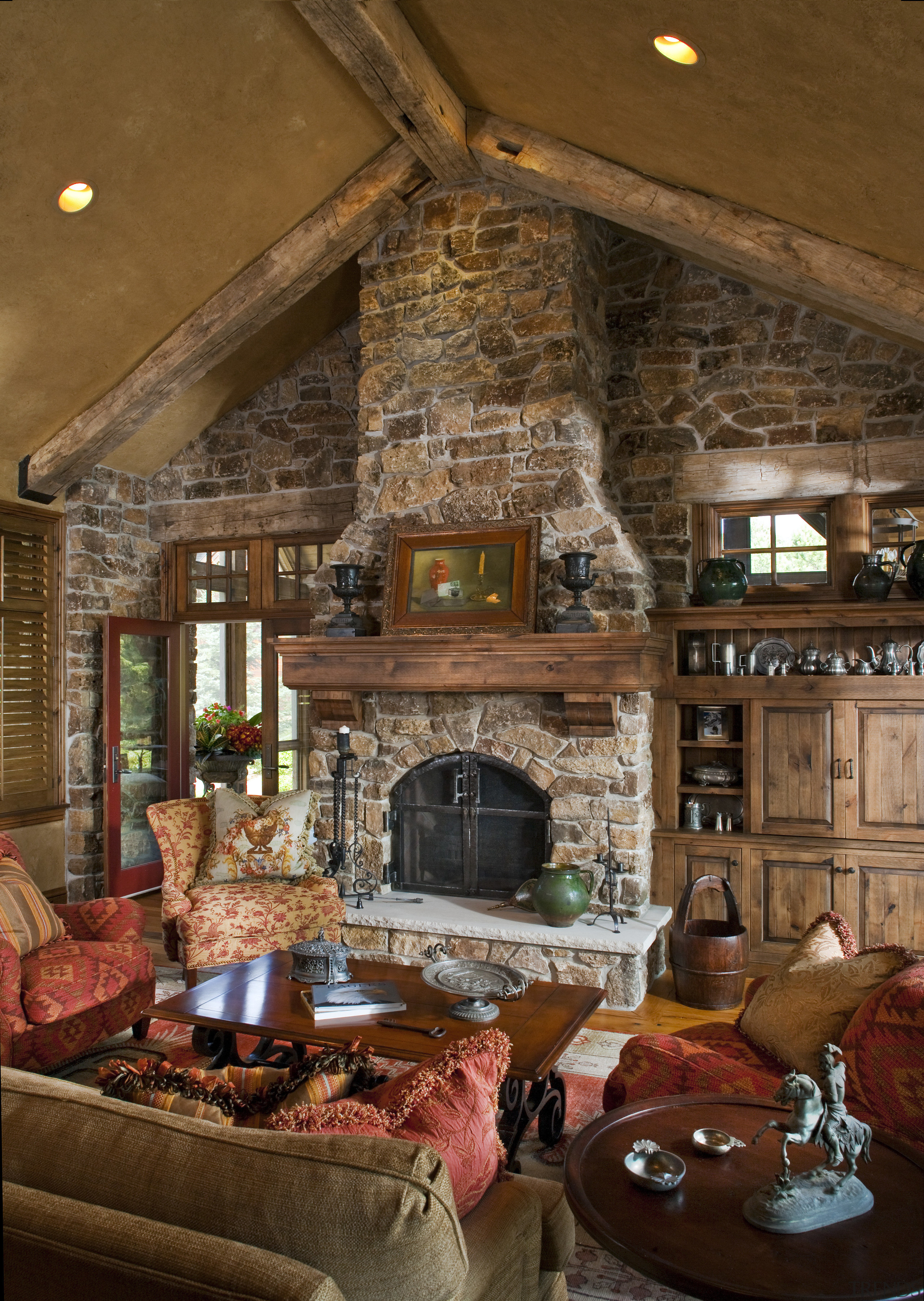 The interior of this home was designed by fireplace, hearth, home, interior design, living room, room, wood, wood burning stove, brown