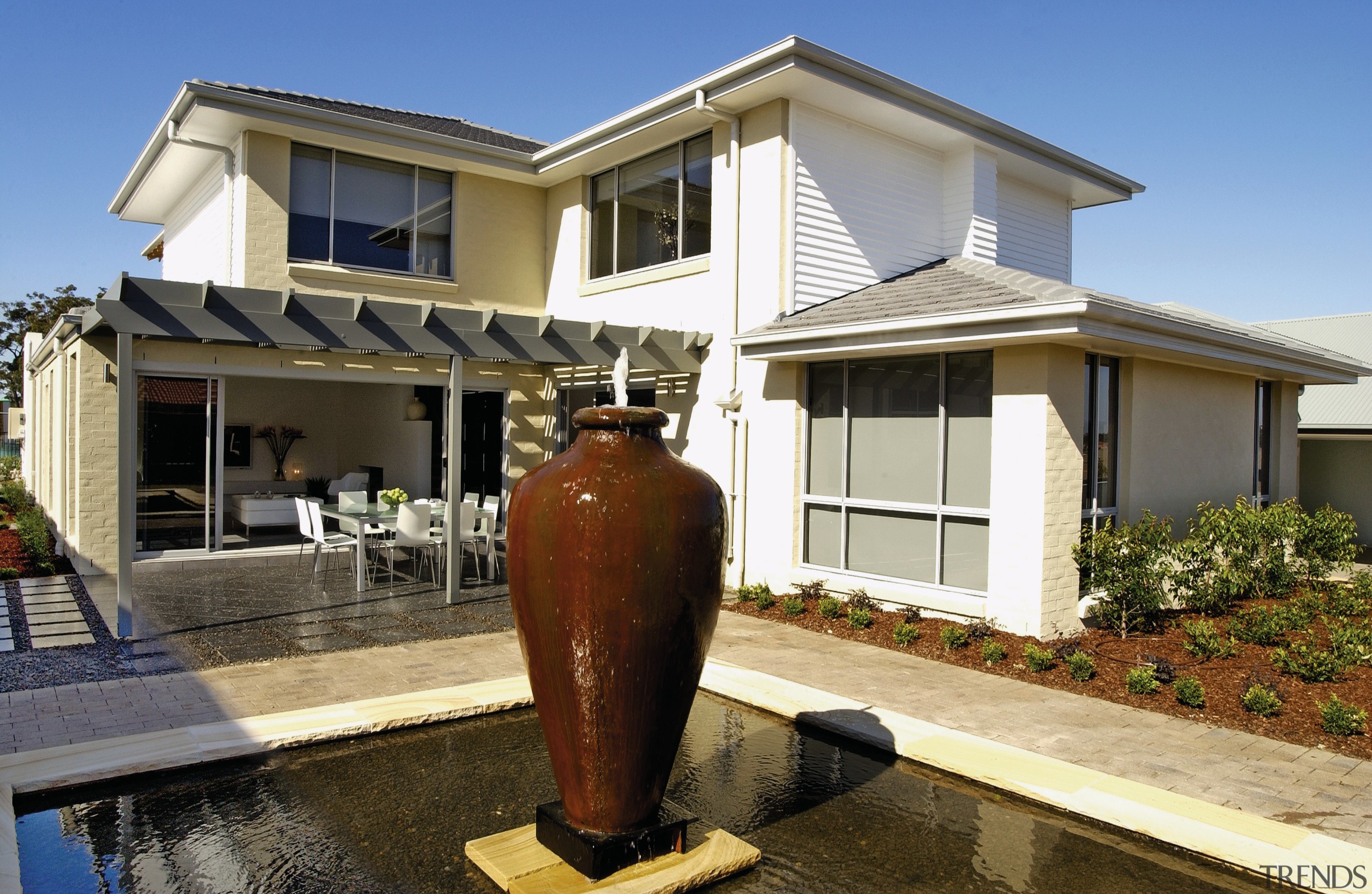 A view of the large water feature with building, facade, home, house, property, real estate, residential area, siding, window, brown