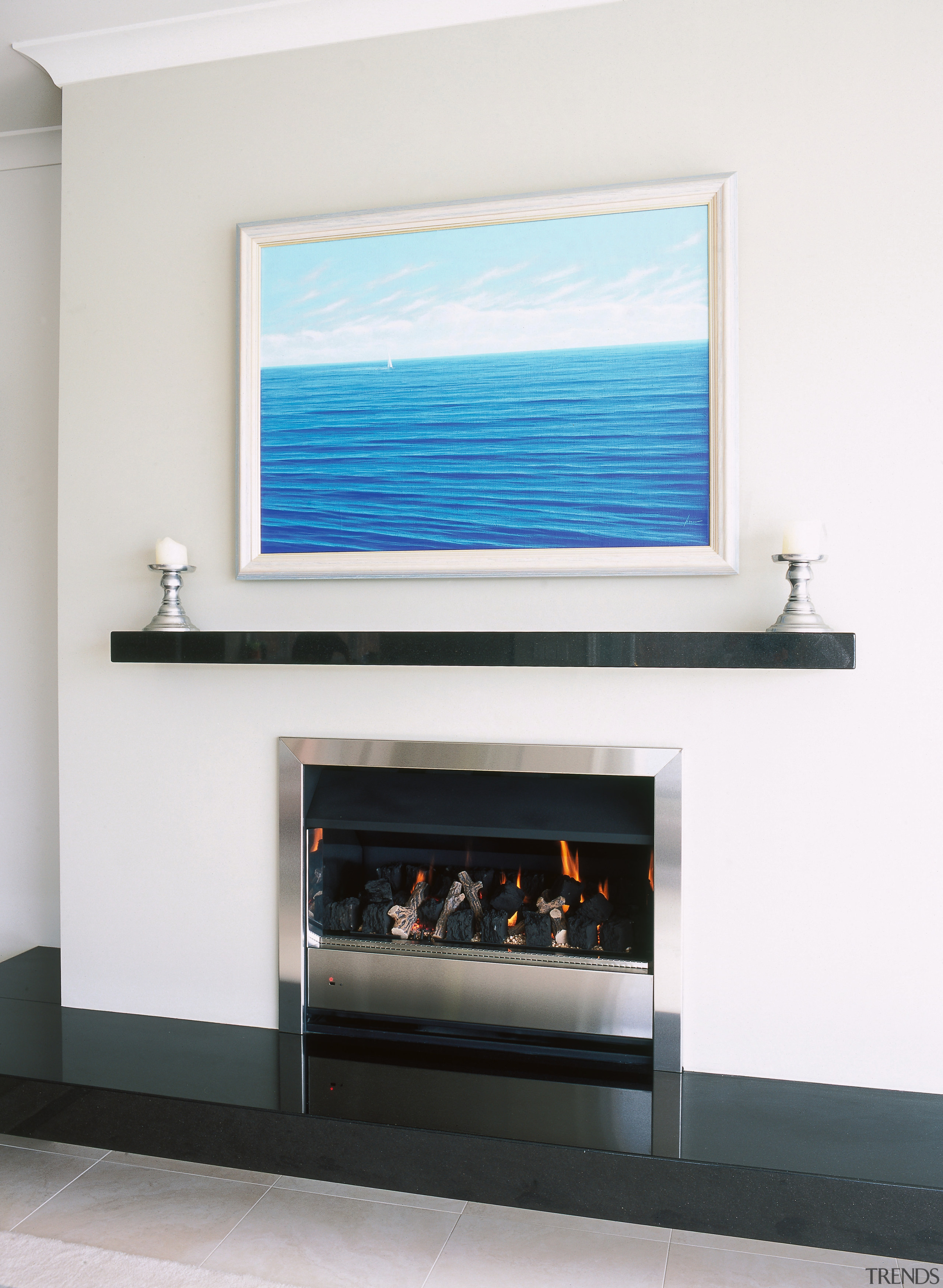Gas fireplace with stainless steel trim, white surround display device, fireplace, flat panel display, hearth, white