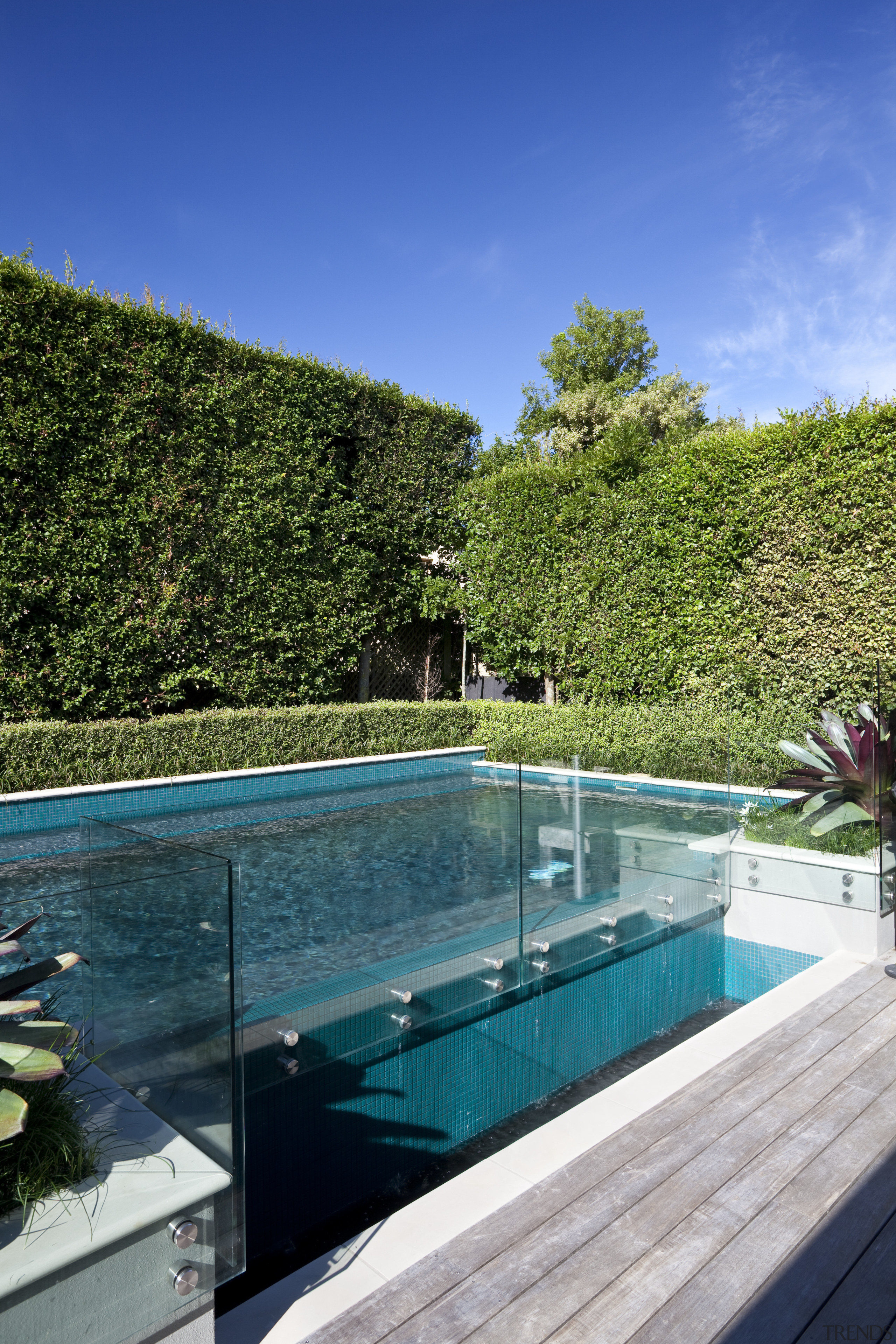 The rear yard of this home has been estate, house, leisure, plant, real estate, reflection, sky, swimming pool, tree, vacation, villa, water, teal