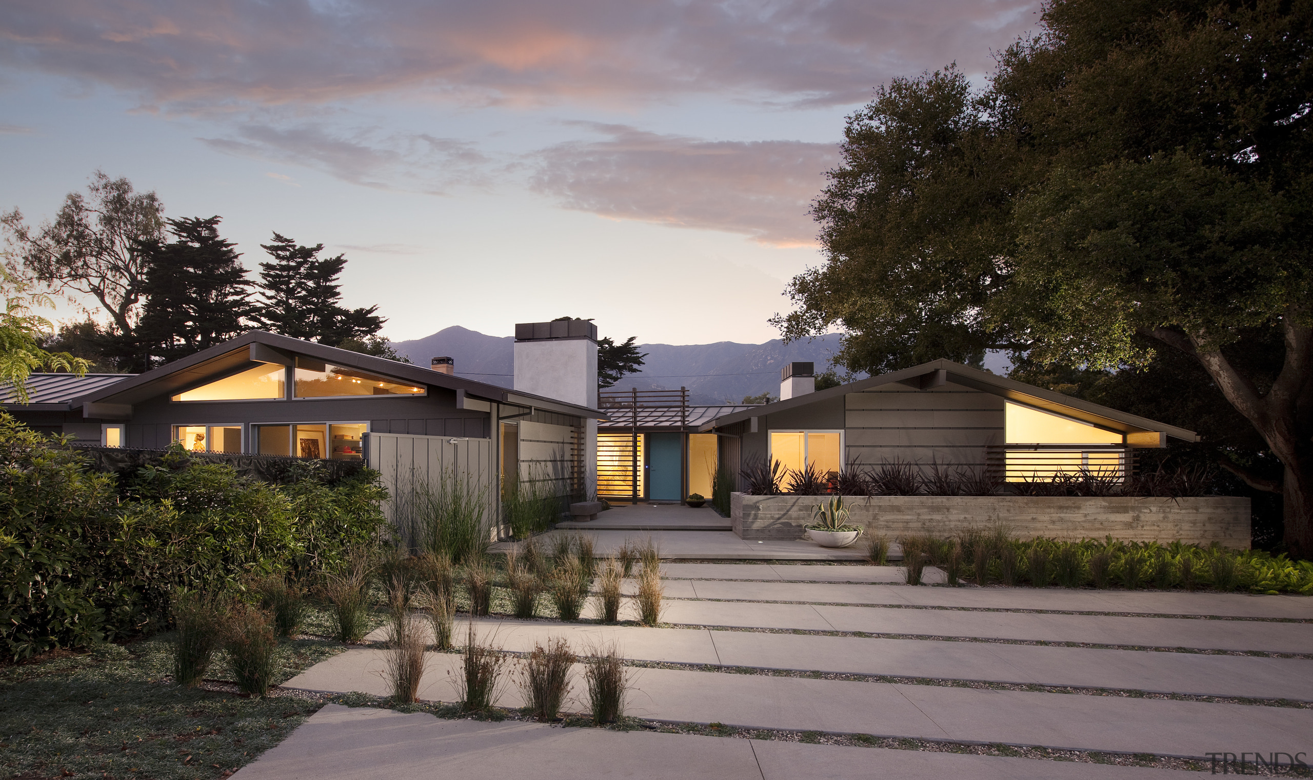 View of a house with landscaped forecourt, pool architecture, cottage, estate, evening, facade, farmhouse, home, house, landscape, lighting, property, real estate, residential area, roof, sky, suburb, gray, black