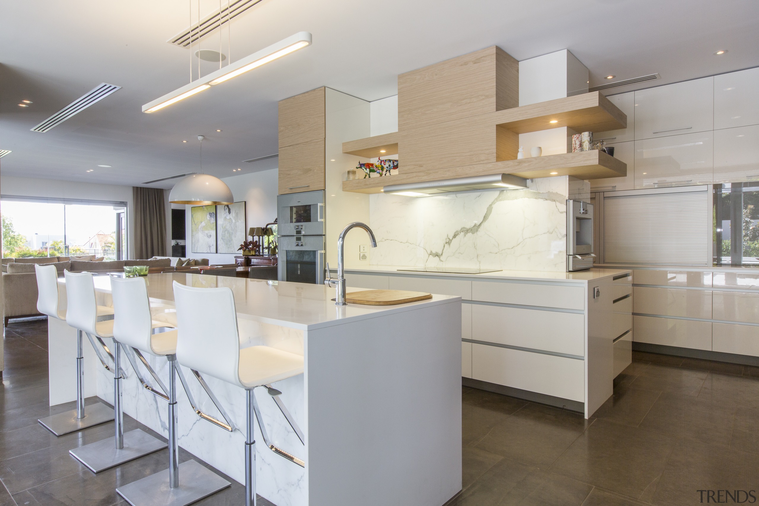 This kitchen in a renovated 1970s house features architecture, cabinetry, countertop, cuisine classique, floor, interior design, kitchen, real estate, gray