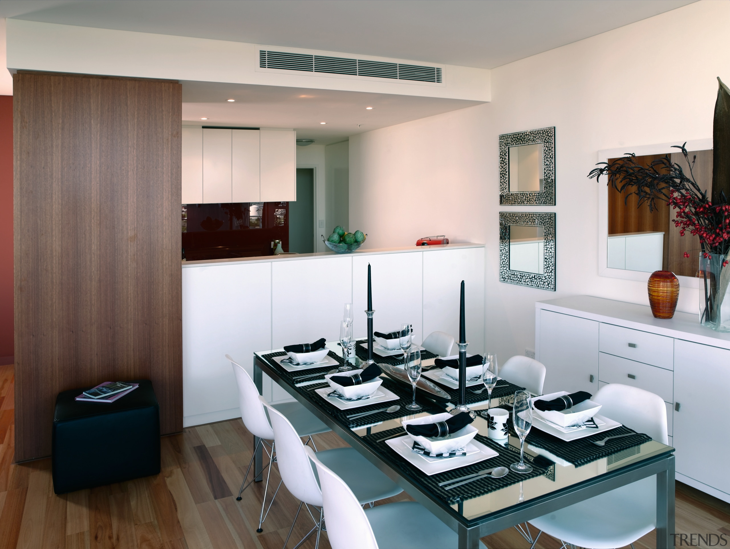 A view of the dining area featuing glass interior design, kitchen, gray