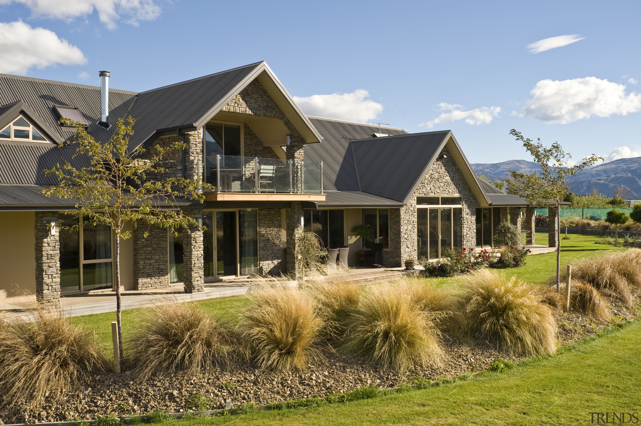 Image of this new home in central Otago cottage, elevation, estate, facade, farmhouse, grass, home, house, landscape, landscaping, lawn, property, real estate, residential area, roof, siding, brown