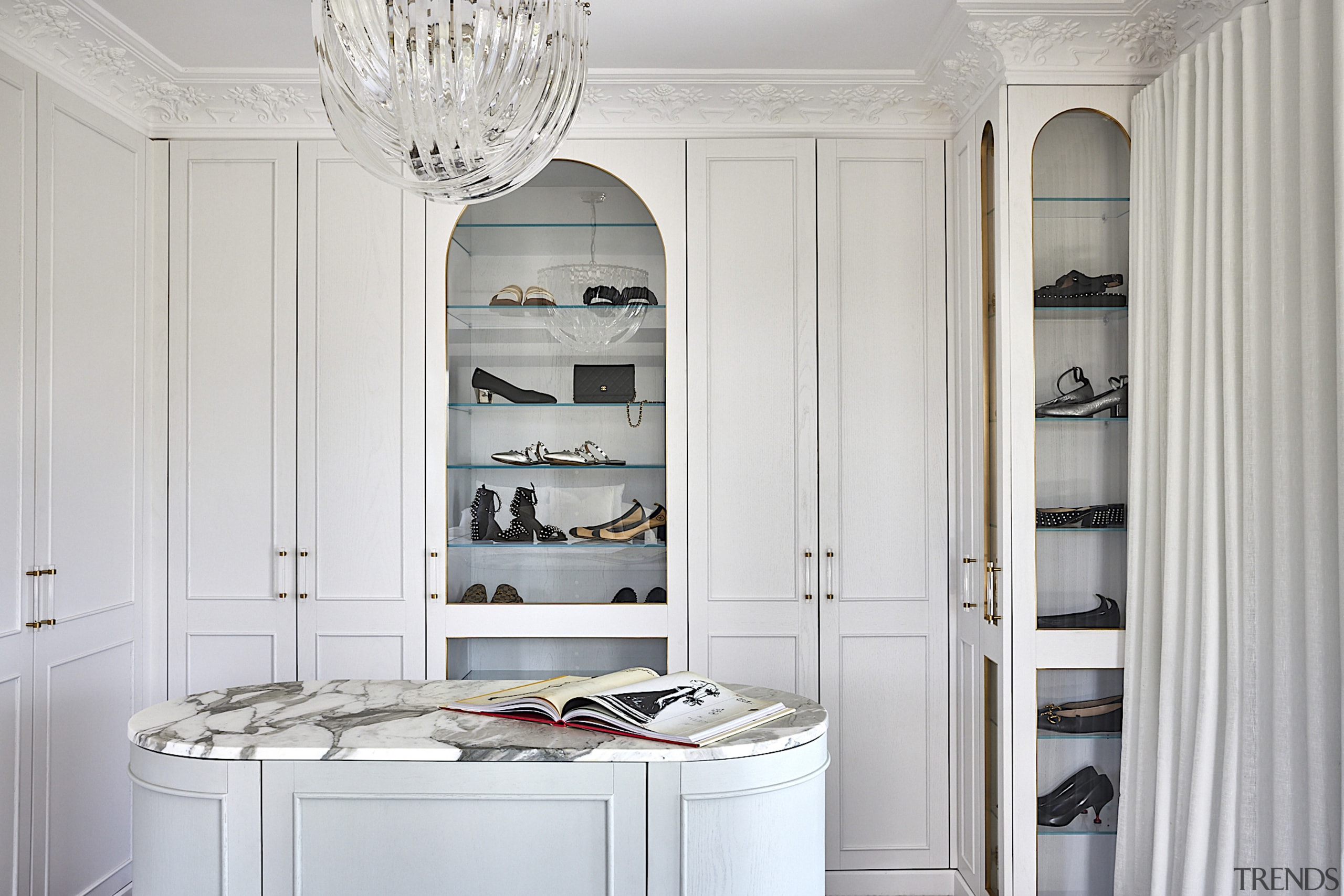 The walk-in dressing room includes display shelving reminiscent 