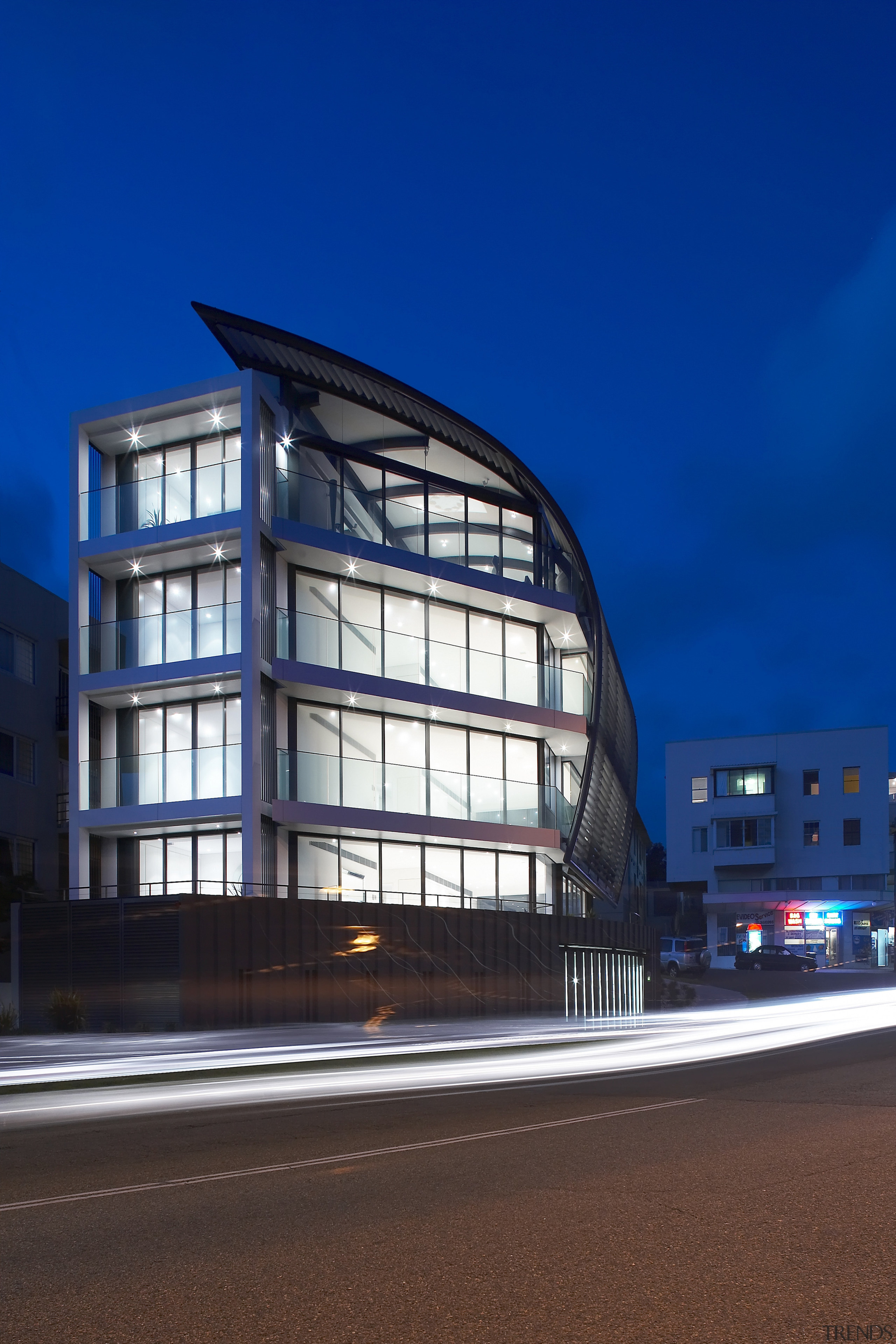 Exterior view of a Sydney apartment building which architecture, building, city, commercial building, condominium, corporate headquarters, facade, headquarters, house, landmark, metropolis, metropolitan area, mixed use, night, reflection, residential area, sky, structure, window, blue