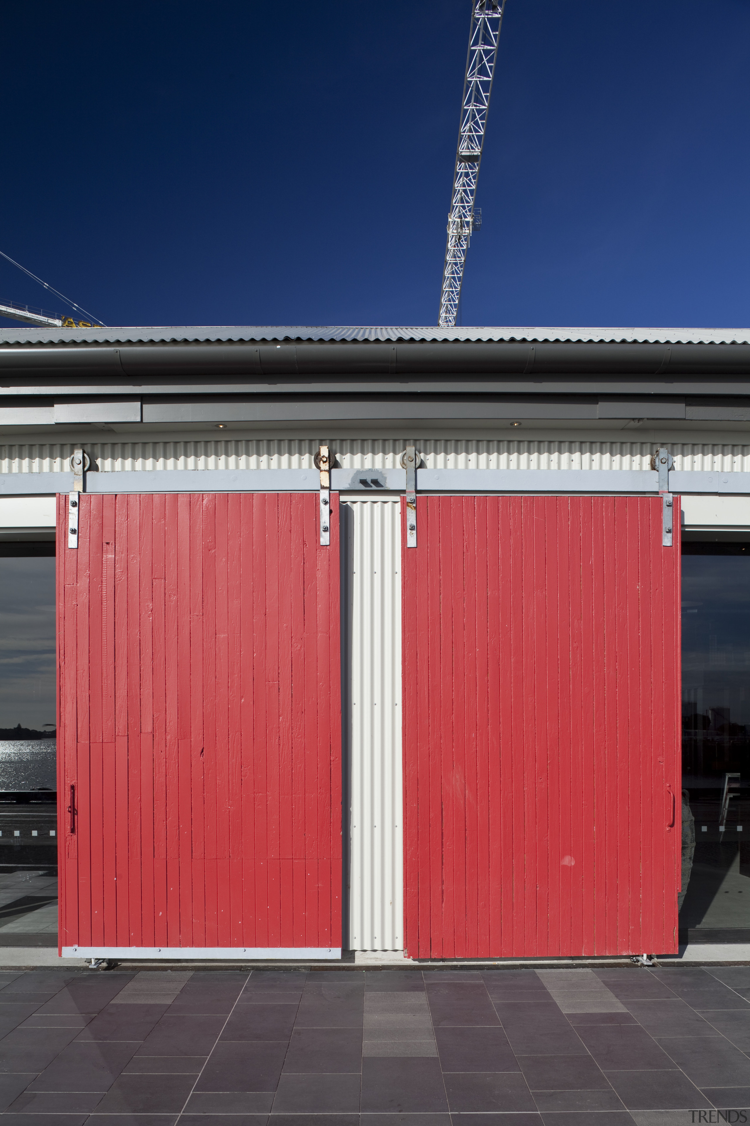 External view of a building in Wynyard Quater architecture, building, door, facade, house, line, red, shed, sky, structure, red, blue