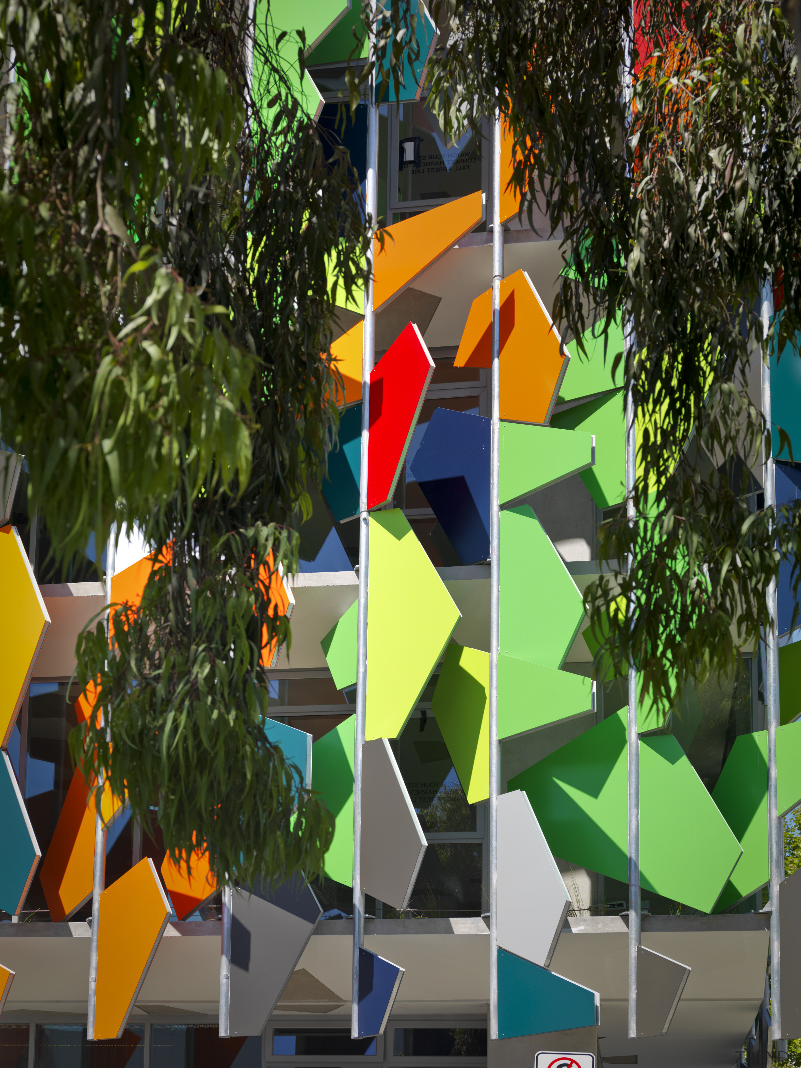 View of Pixel Building, with colorful exterior flags, art, green, plant, tree