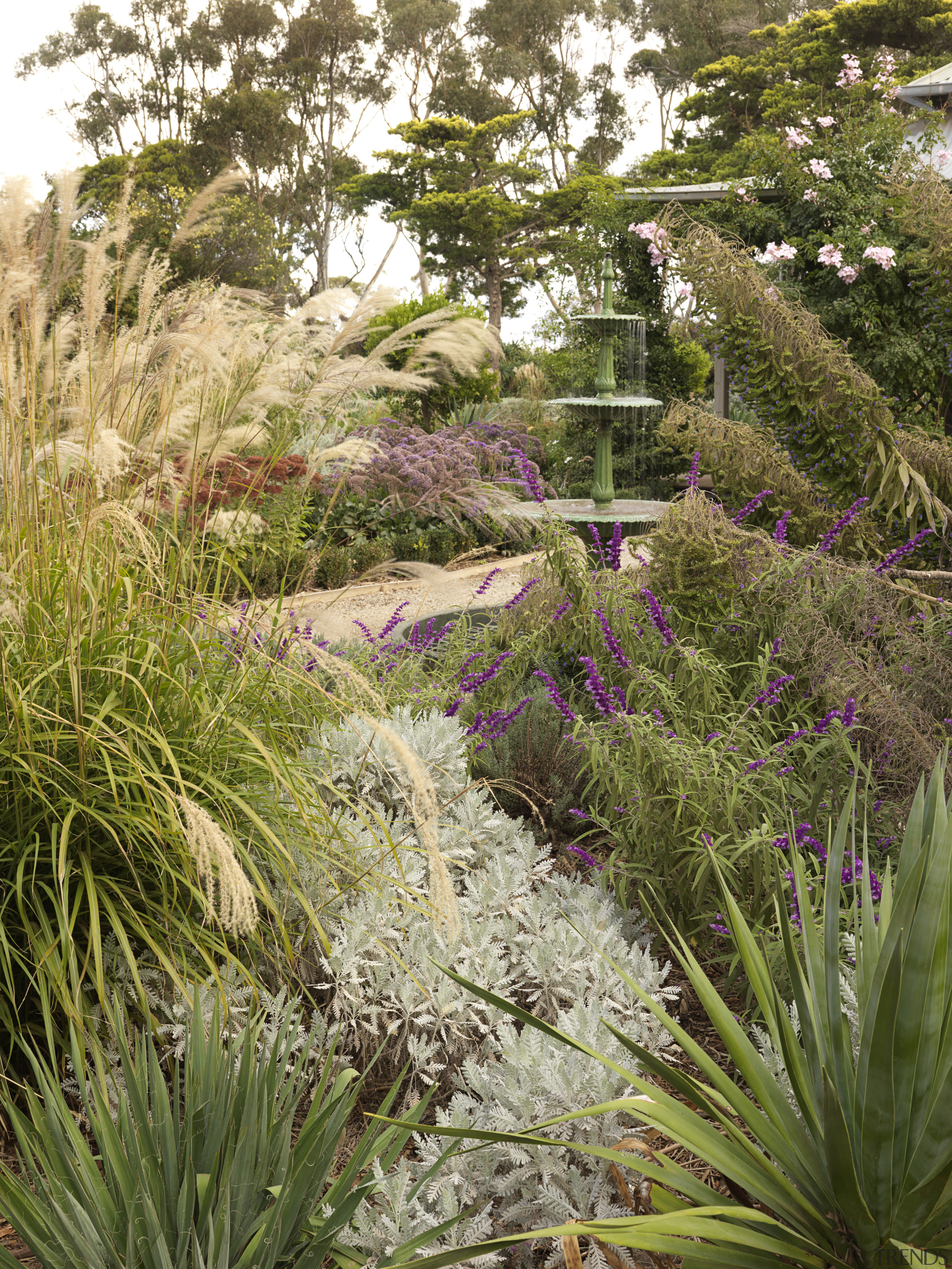 View of garden which features an antique fountain botanical garden, flora, flower, garden, grass, grass family, landscape, landscaping, plant, shrub, tree, vegetation, brown