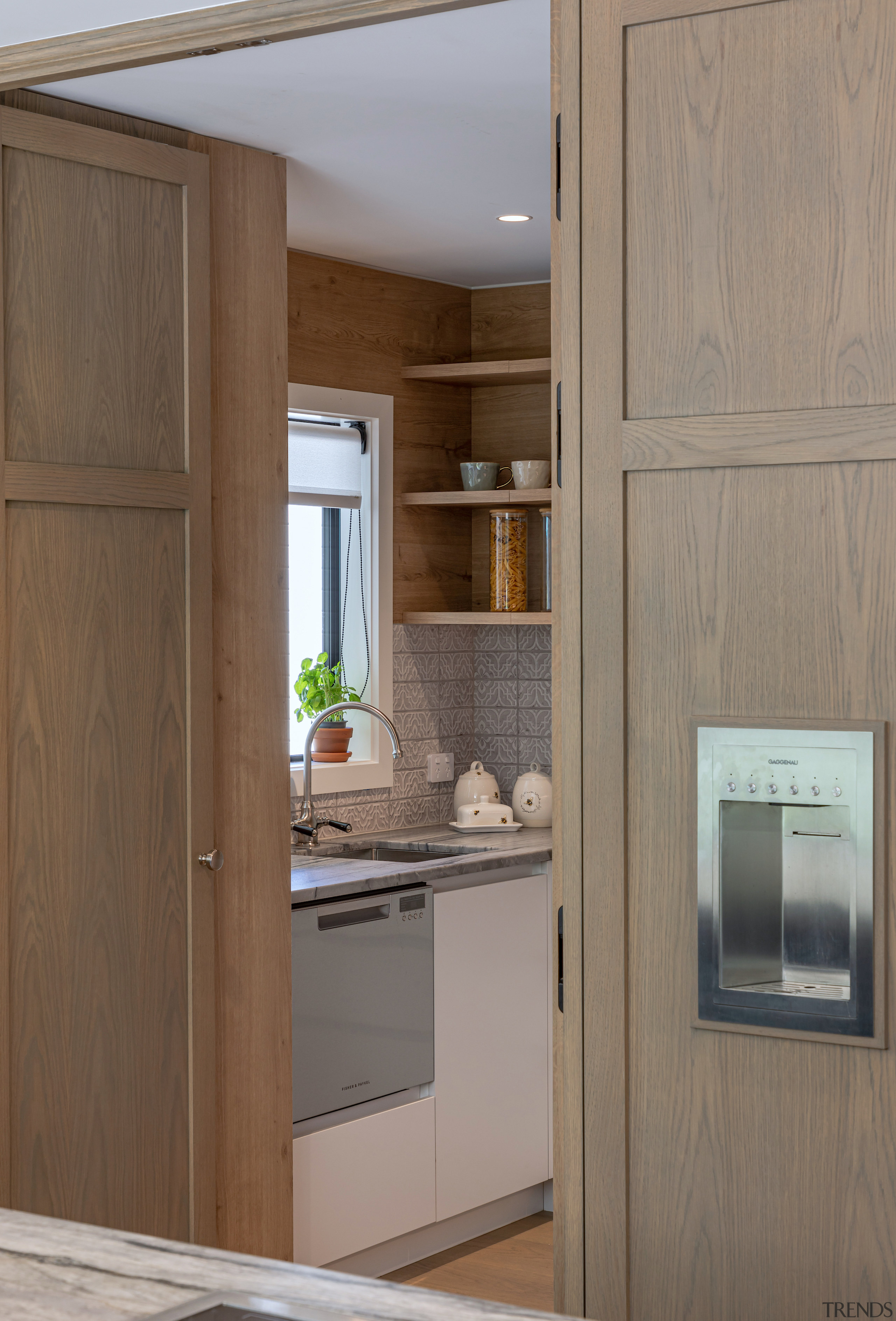 Hidden within the joinery woodwork, panelled doors open 