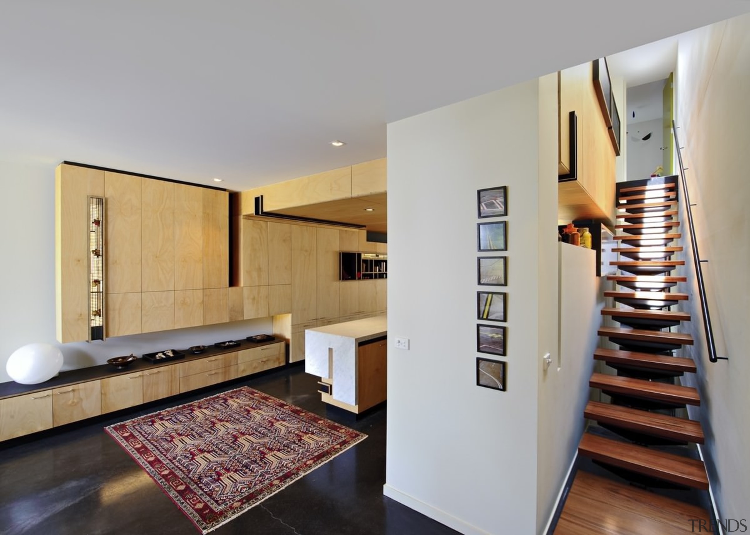 The stair sits ensconced in a passage to floor, flooring, interior design, real estate, gray