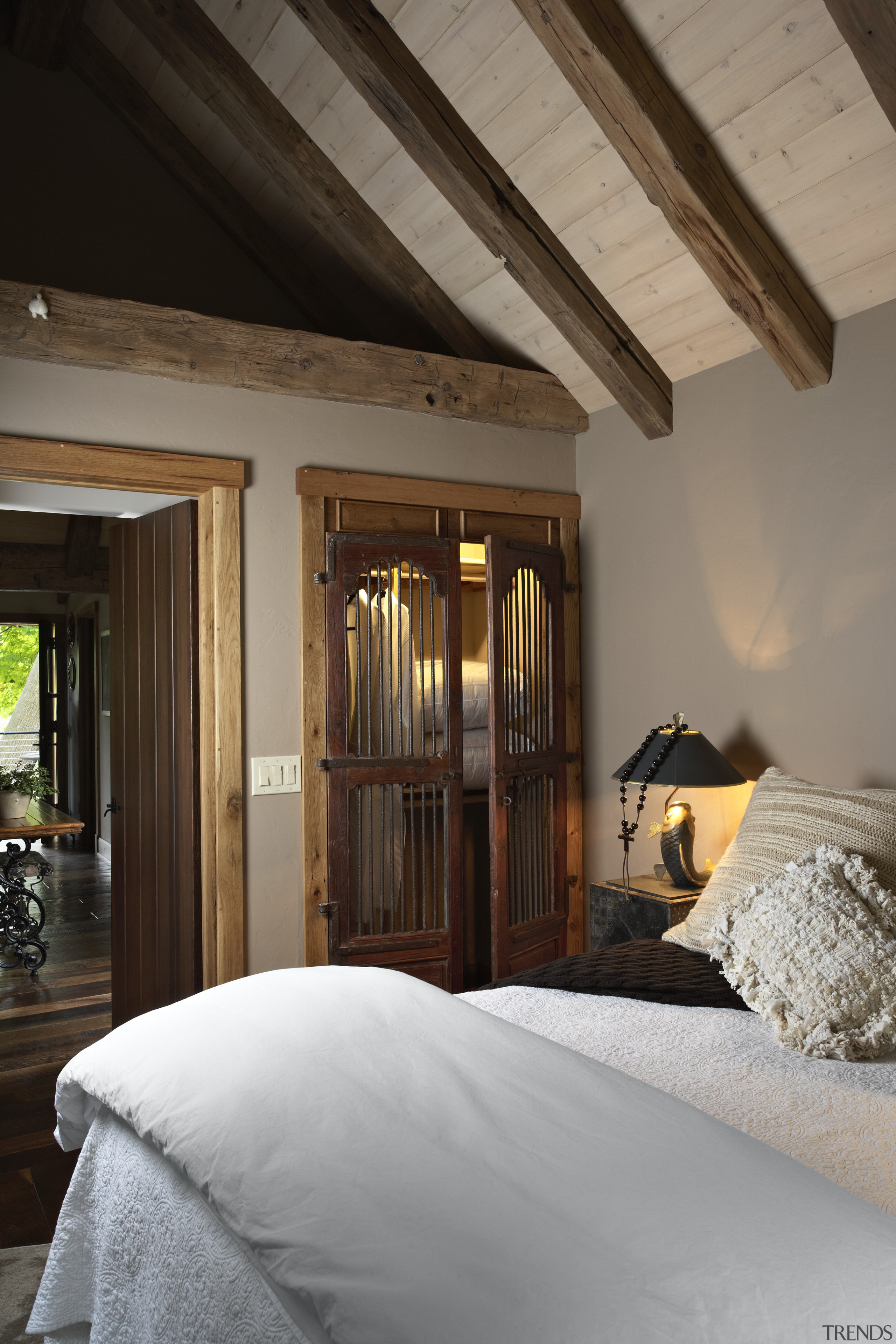 Bedroom with white bedding and exposed ceiling beams. architecture, beam, bed frame, bedroom, ceiling, home, house, interior design, room, window, wood, brown, gray