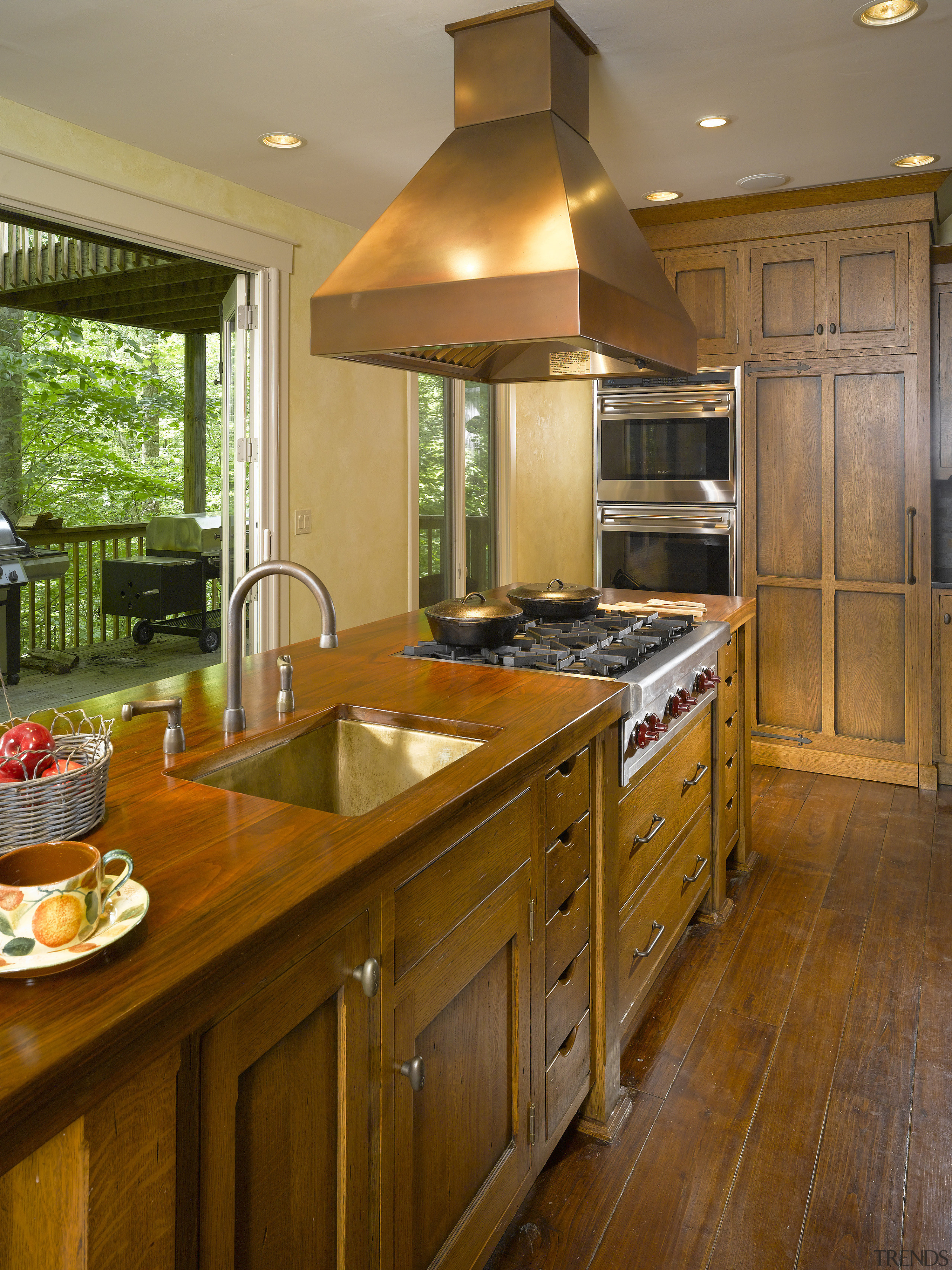 View of a kitchen which features an island cabinetry, countertop, cuisine classique, hardwood, home, interior design, kitchen, real estate, room, brown