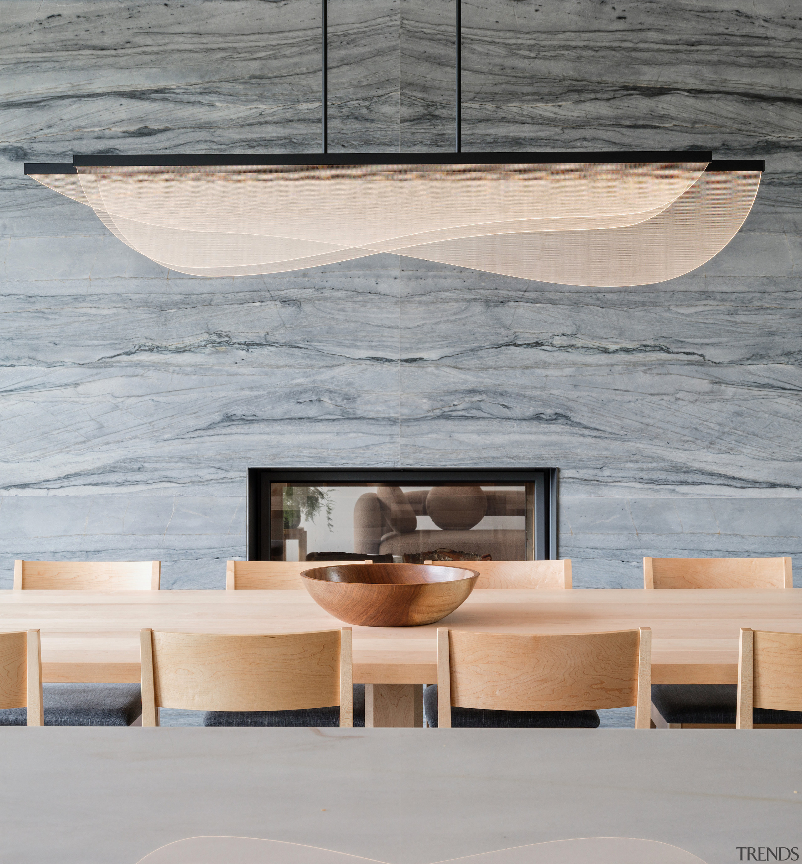 A sculptural pendant sails over the dining table. 