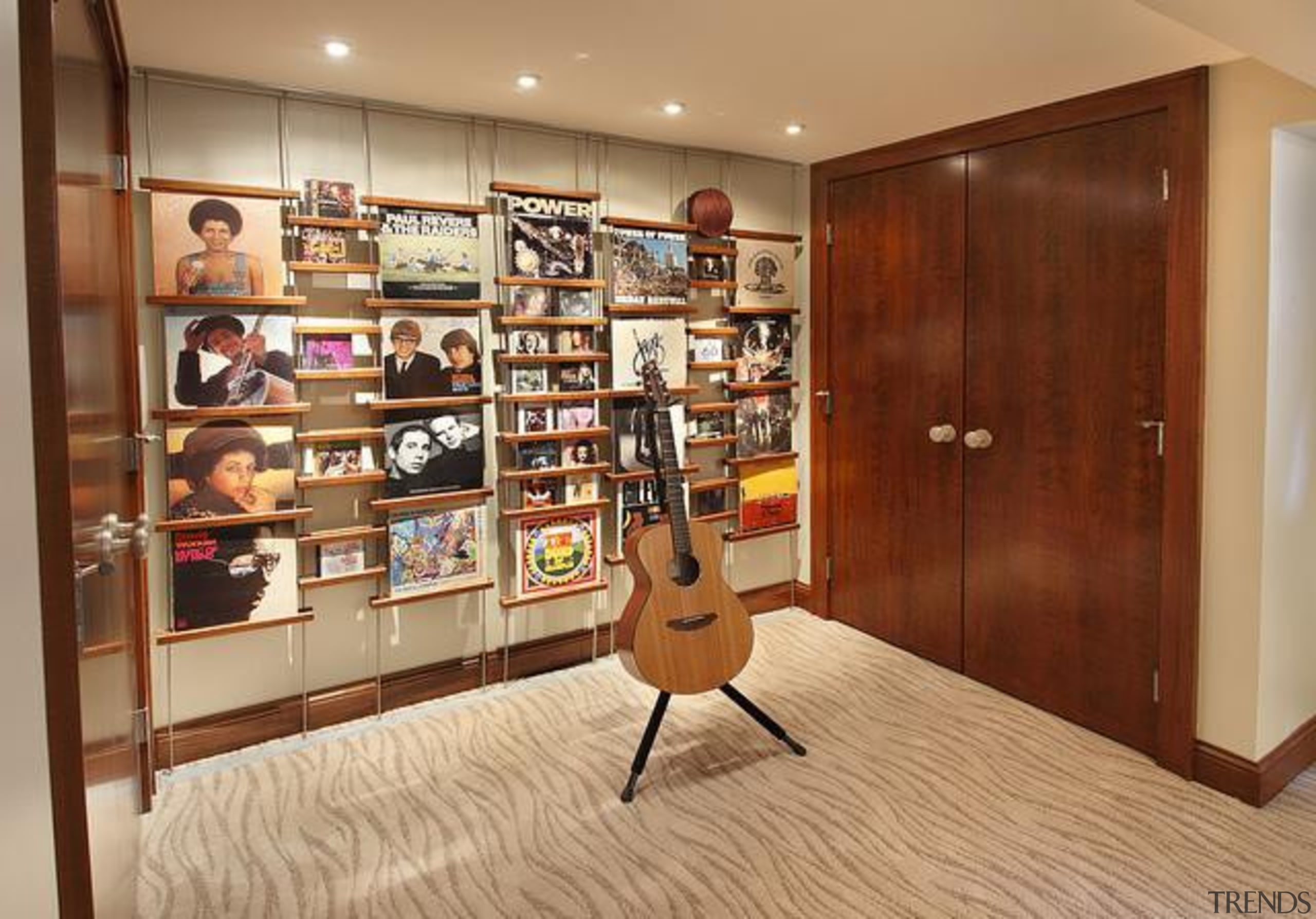 Because of its expansive and wide-open layout, a bookcase, cabinetry, closet, floor, flooring, furniture, hardwood, interior design, room, shelving, brown, orange