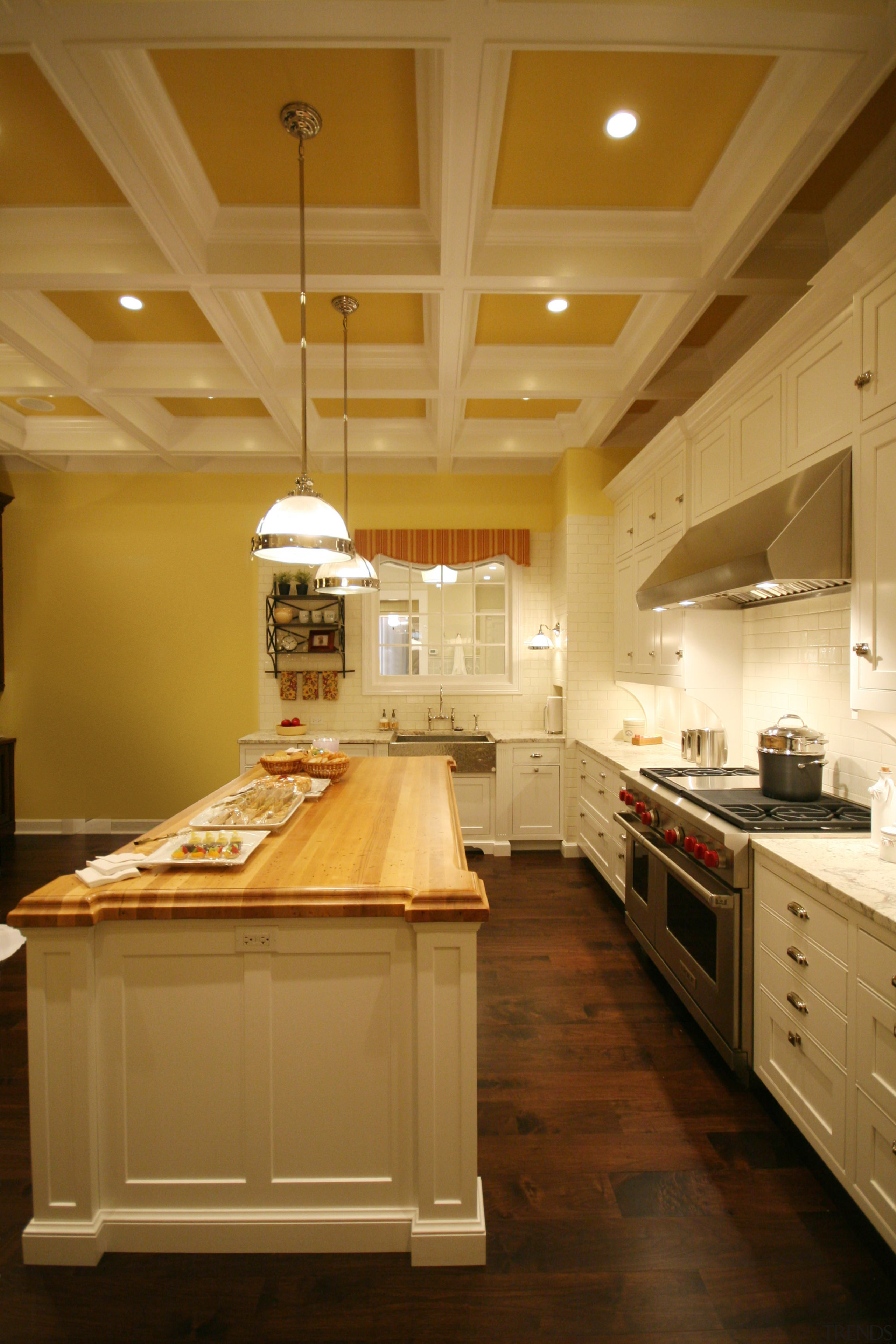 View of the Kitchen with a wooden island cabinetry, ceiling, countertop, cuisine classique, floor, flooring, hardwood, home, interior design, kitchen, lighting, room, under cabinet lighting, wood, wood flooring, brown, orange