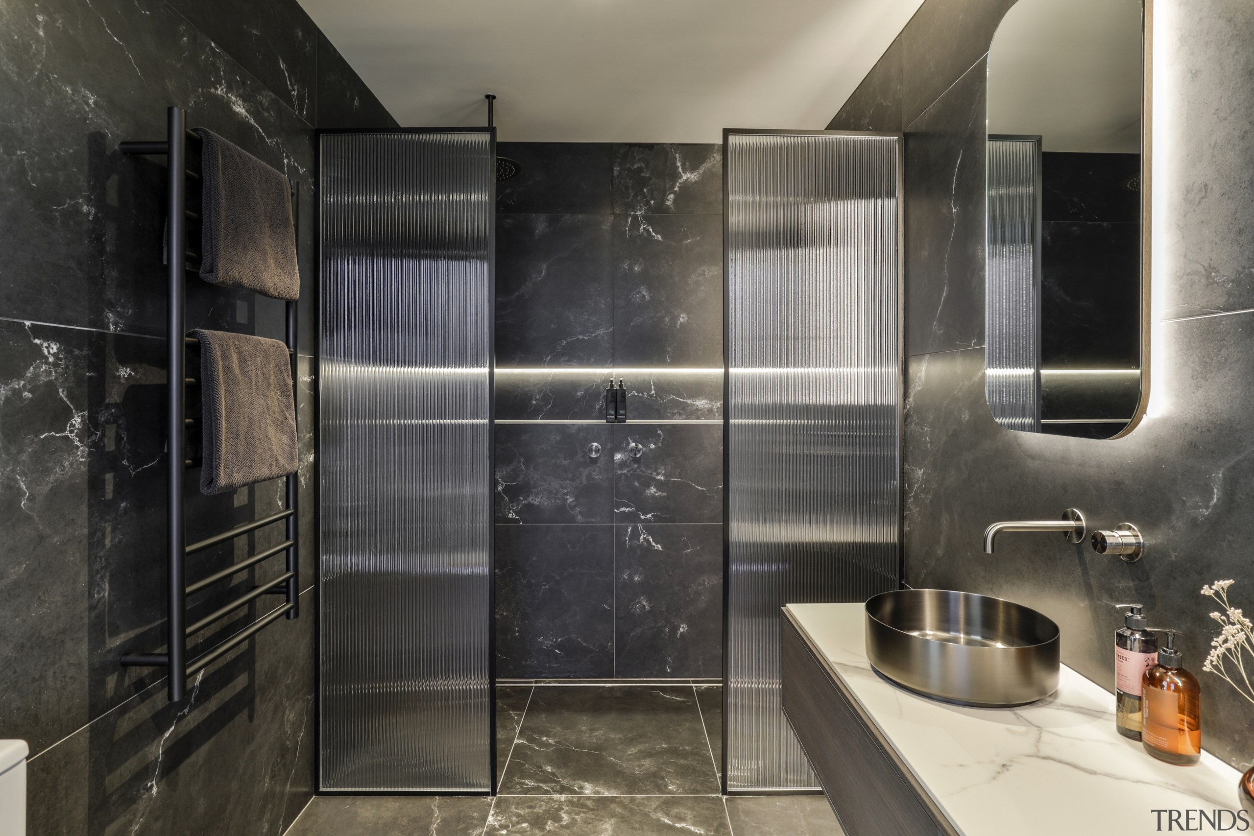 The ensuite has a dark and moody atmosphere, 