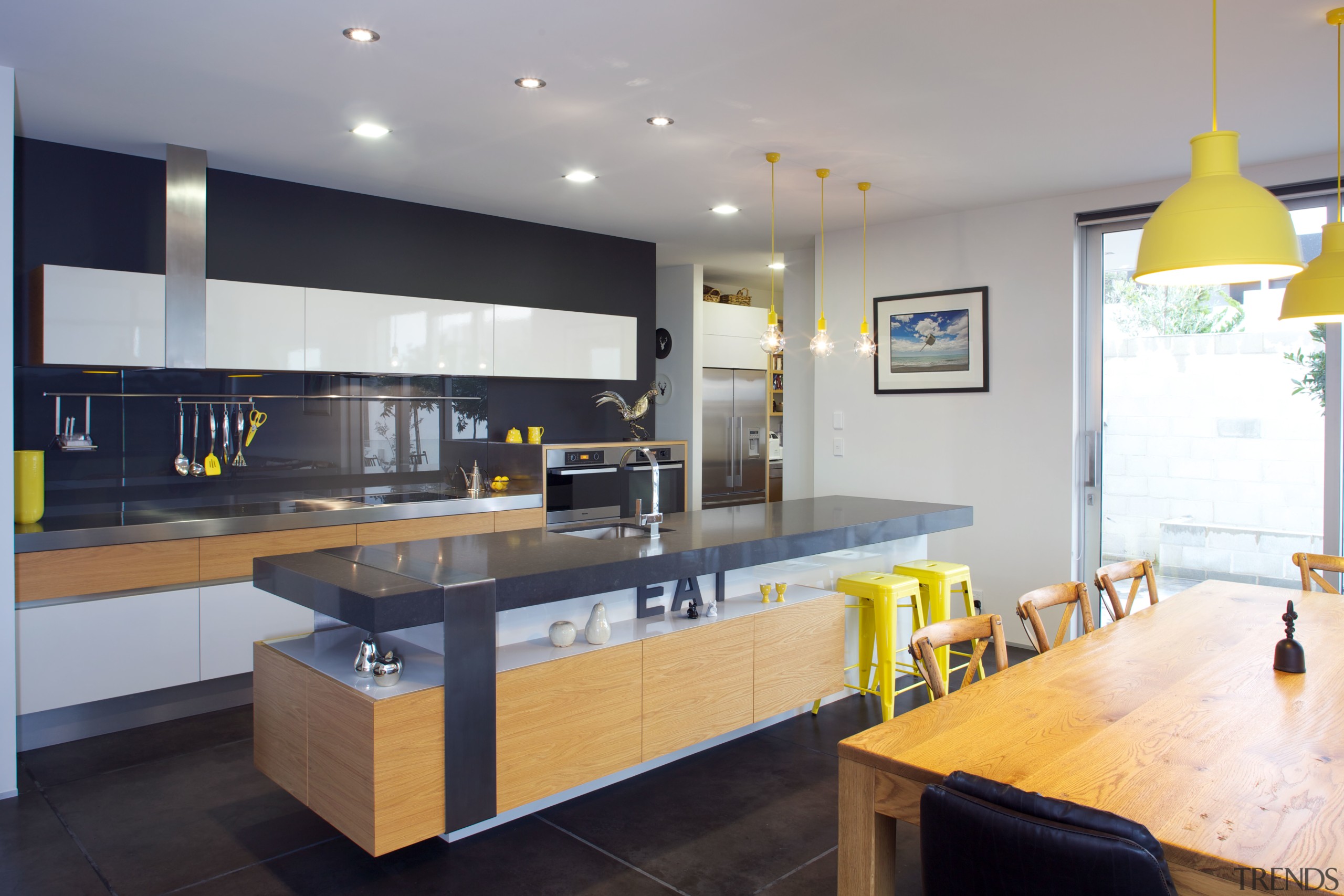 Large sliding doors in this kitchen open up countertop, interior design, kitchen, real estate, gray
