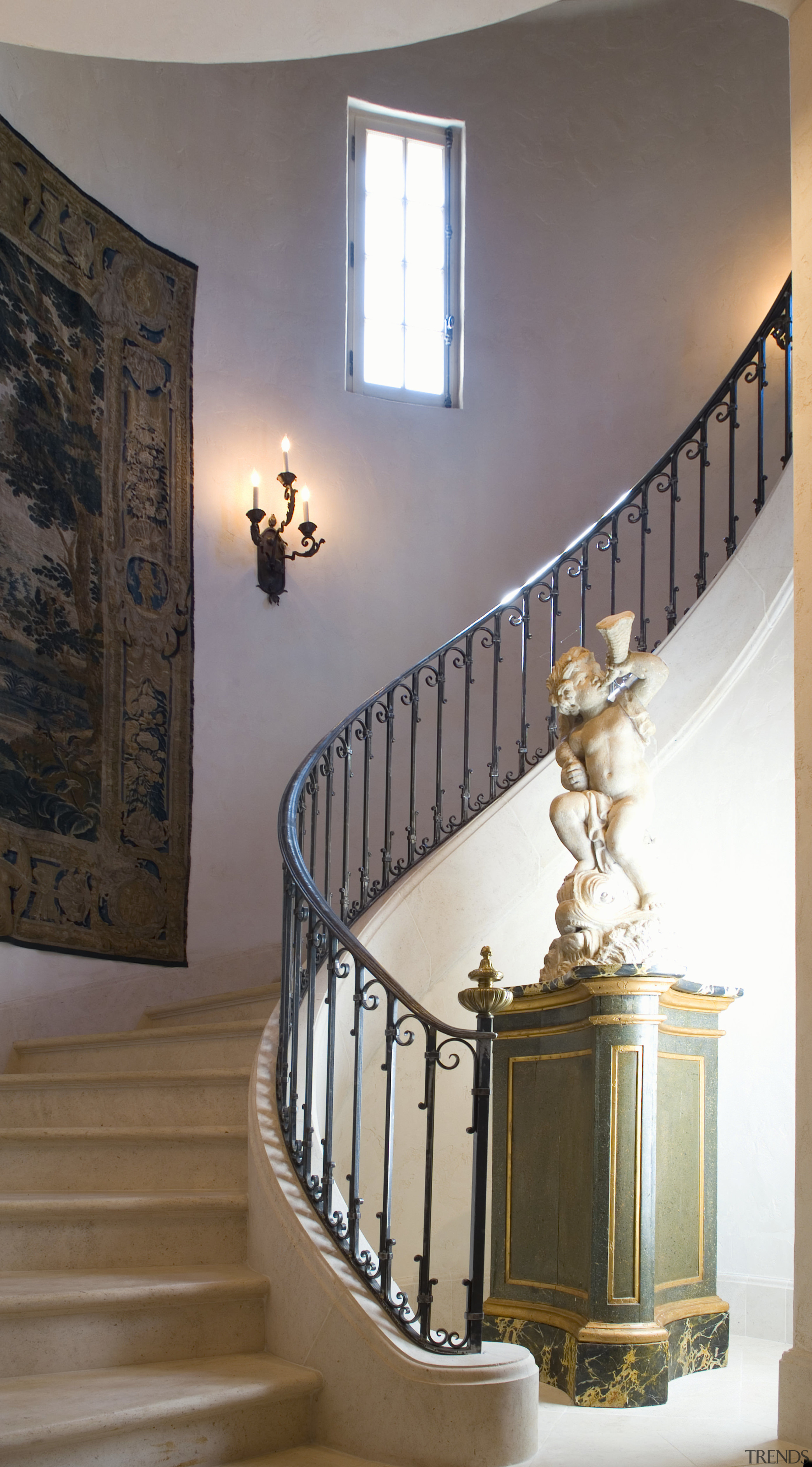 View of staircase, lighting, statue, wrought iron handrail. baluster, ceiling, estate, floor, handrail, home, interior design, light fixture, lighting, molding, stairs, wall, gray