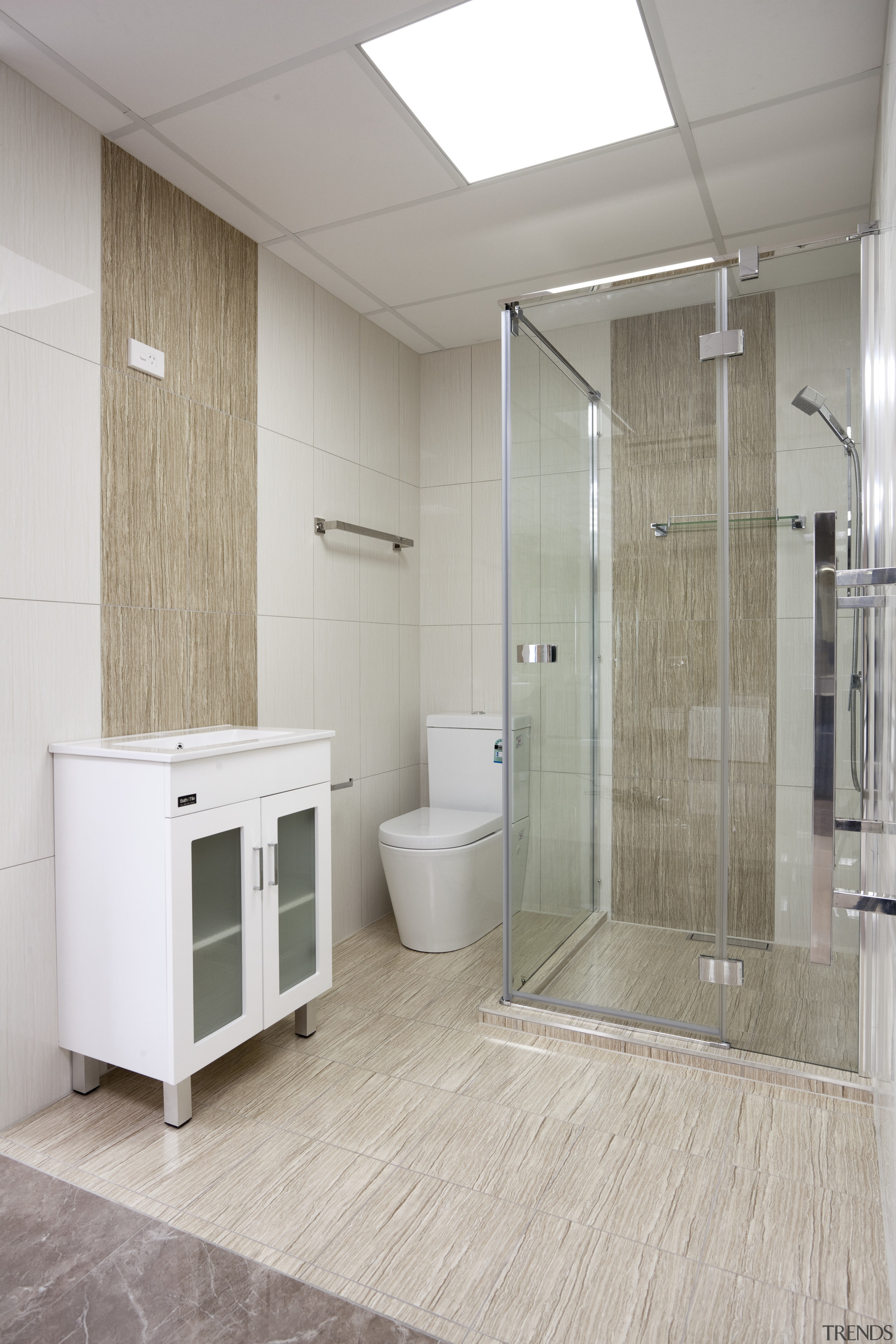 Bathroom with beige and cream walls, white vanity bathroom, floor, flooring, interior design, plumbing fixture, room, tile, gray