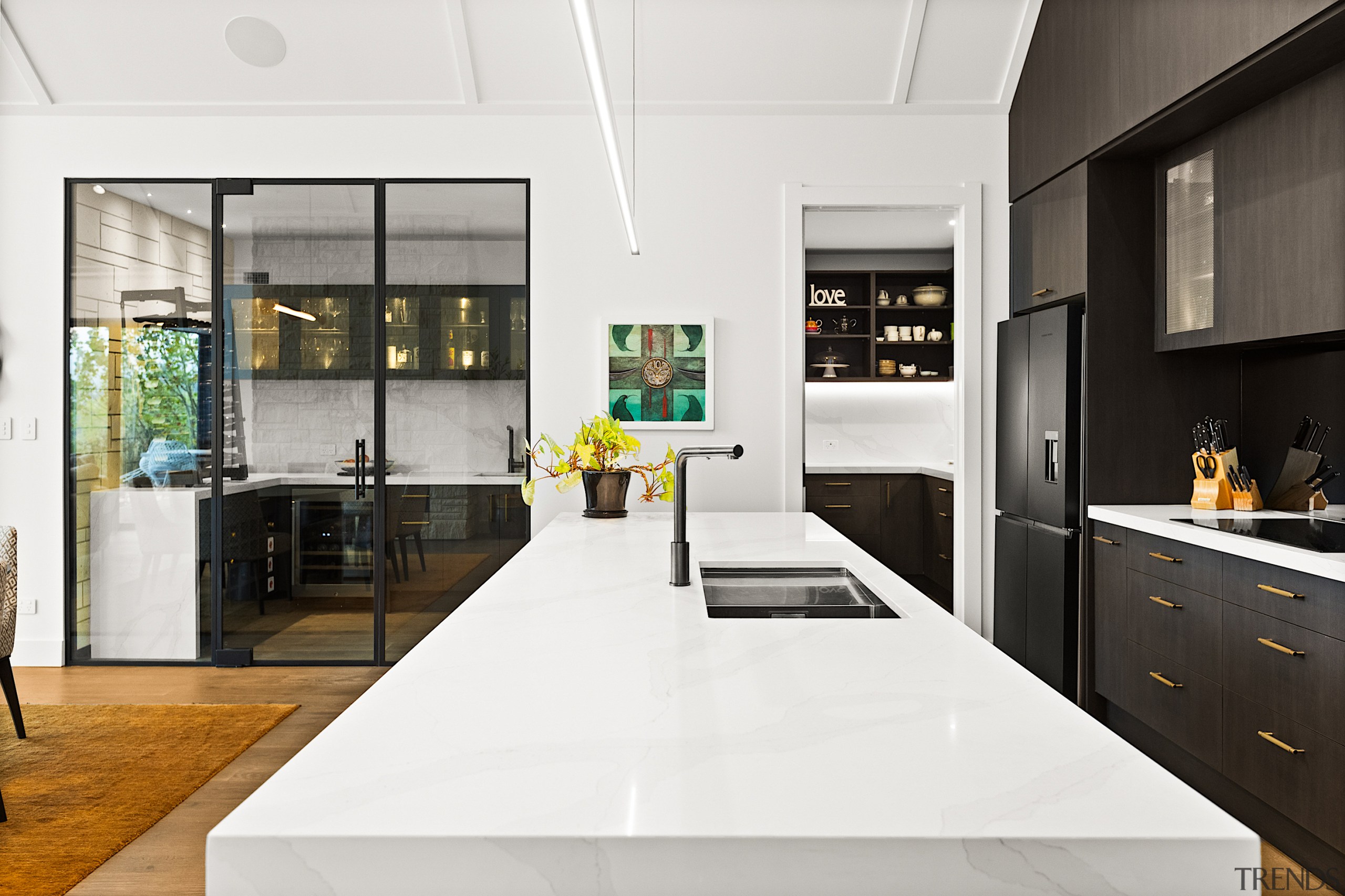 Anchoring the space is the expansive stone island, 