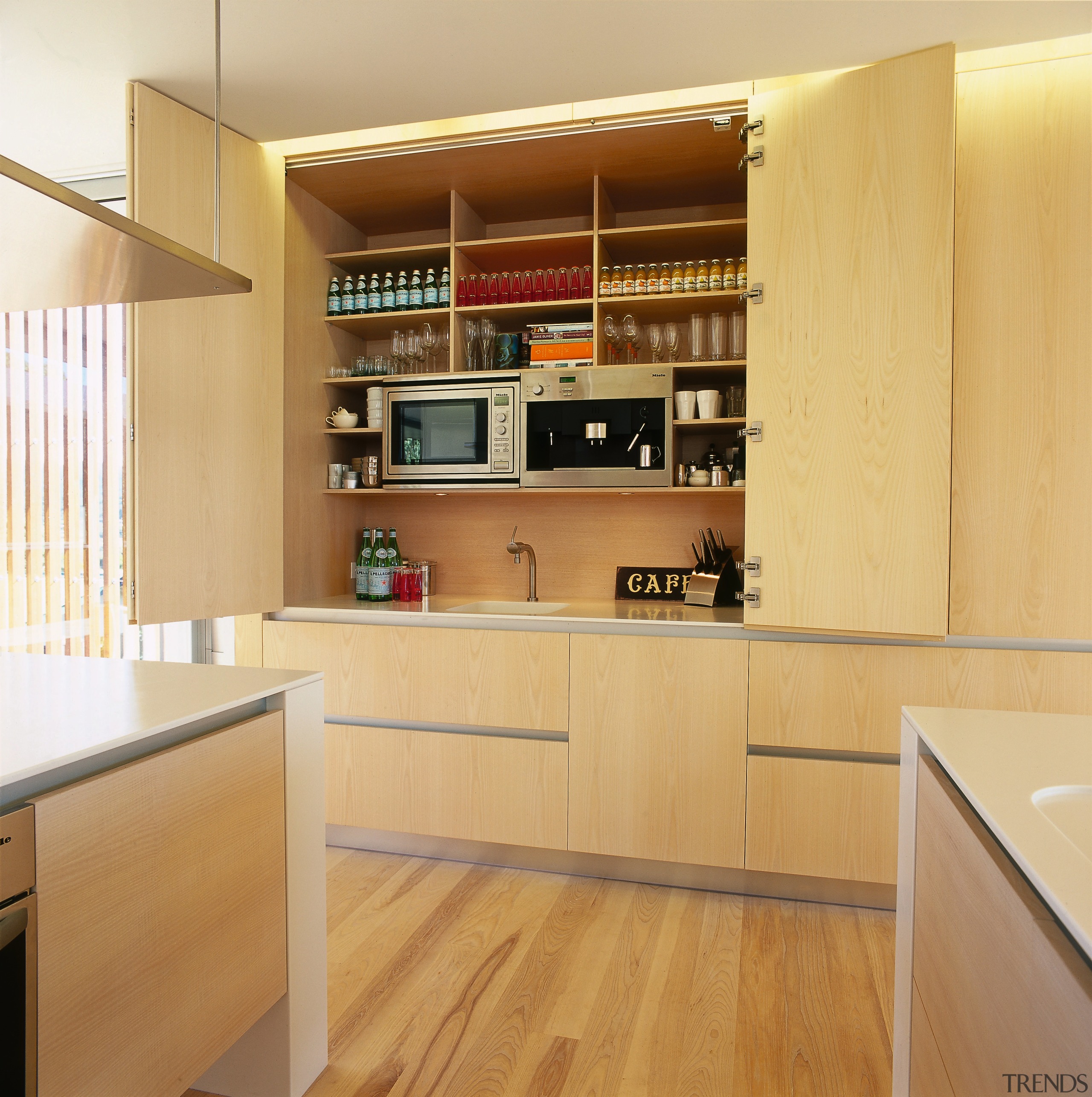 A view of a kitchen area, wooden flooring cabinetry, countertop, cuisine classique, floor, flooring, furniture, hardwood, interior design, kitchen, plywood, shelf, shelving, wood, wood flooring, orange